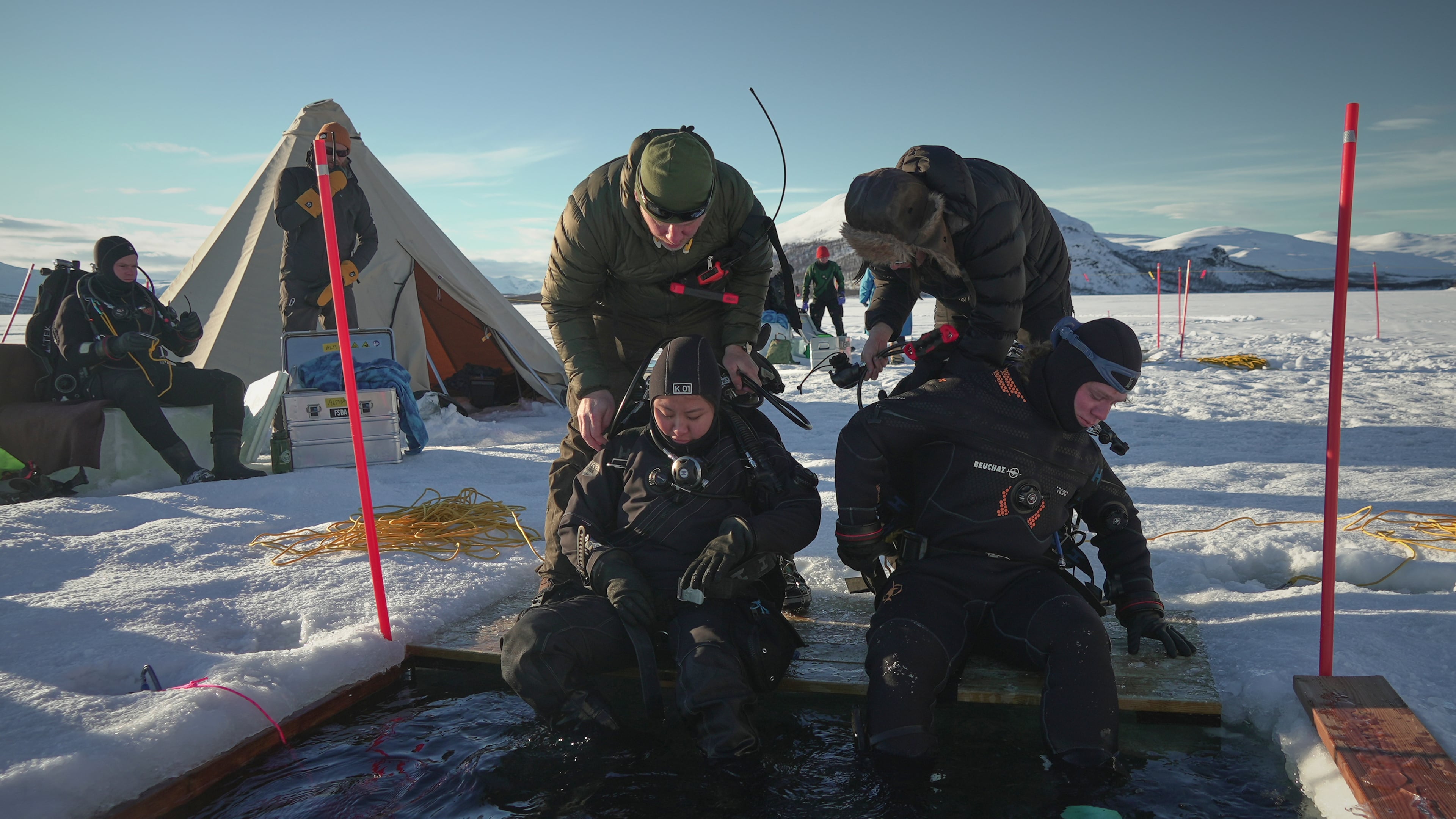 Ruari Buijs, a marine biology and oceanography student, right, and Caroline Chen, a scientific diver and research assistant, prepare to dive during a Polar Scientific Diving class in Kilpisjärvi, March 15, 2026. (AP Photo/Kostya Manenkov)