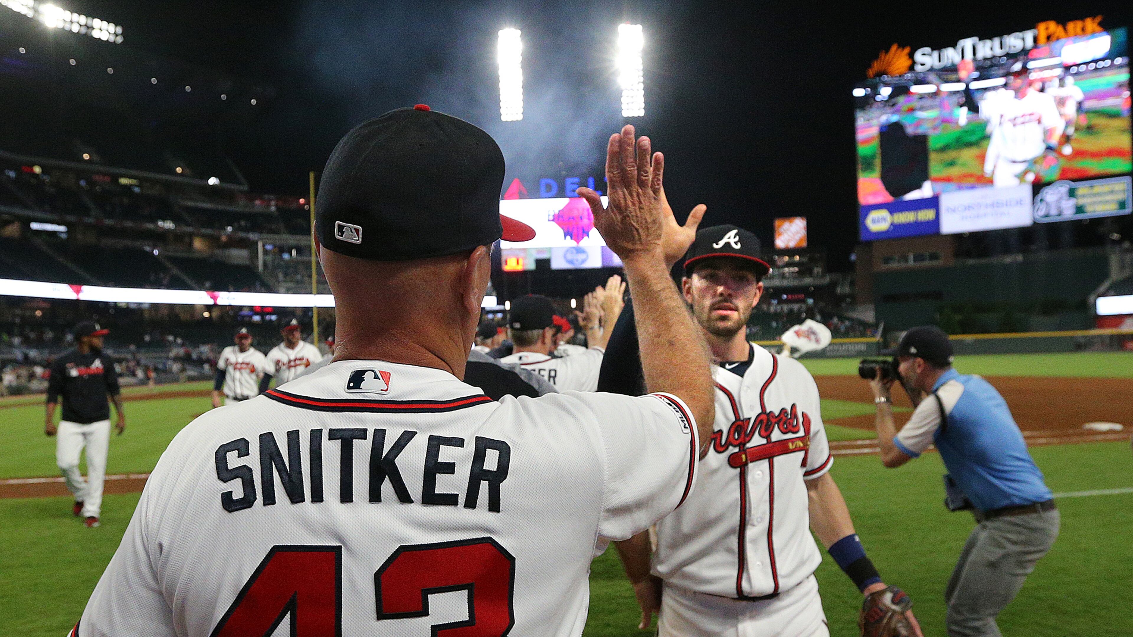 Braves manager Brian Snitker gives Dansby Swanson five after a 5-1 victory over the San Diego Padres on Wednesday, May 1, 2019, in Atlanta.