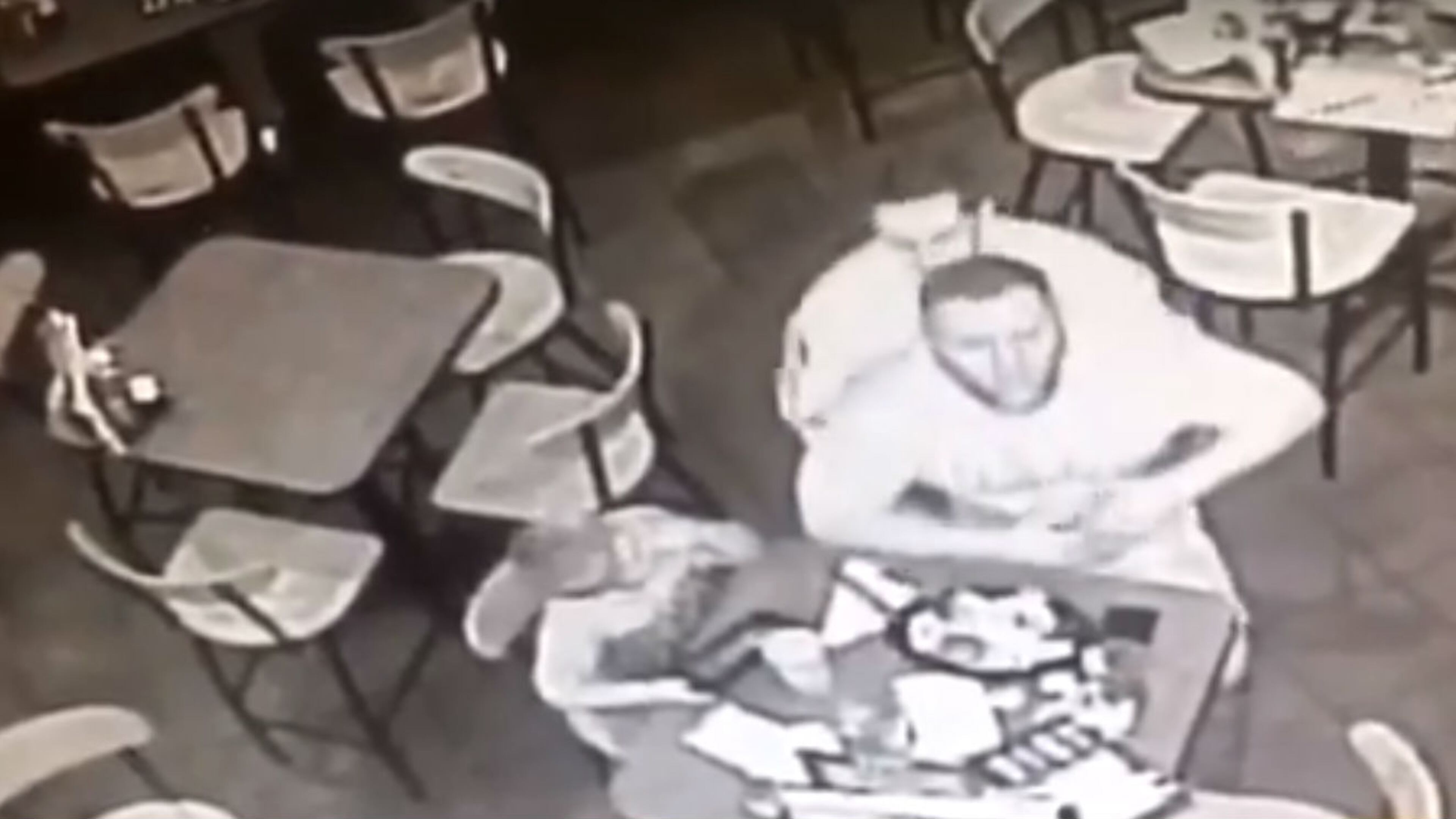 In a still from a surveillance camera, off-duty New Jersey state Trooper performs the Heimlich maneuver on a choking man Sunday, Oct. 22, 2017, at a Rockaway Township restaurant. The trooper is being praised for saving the man's life.