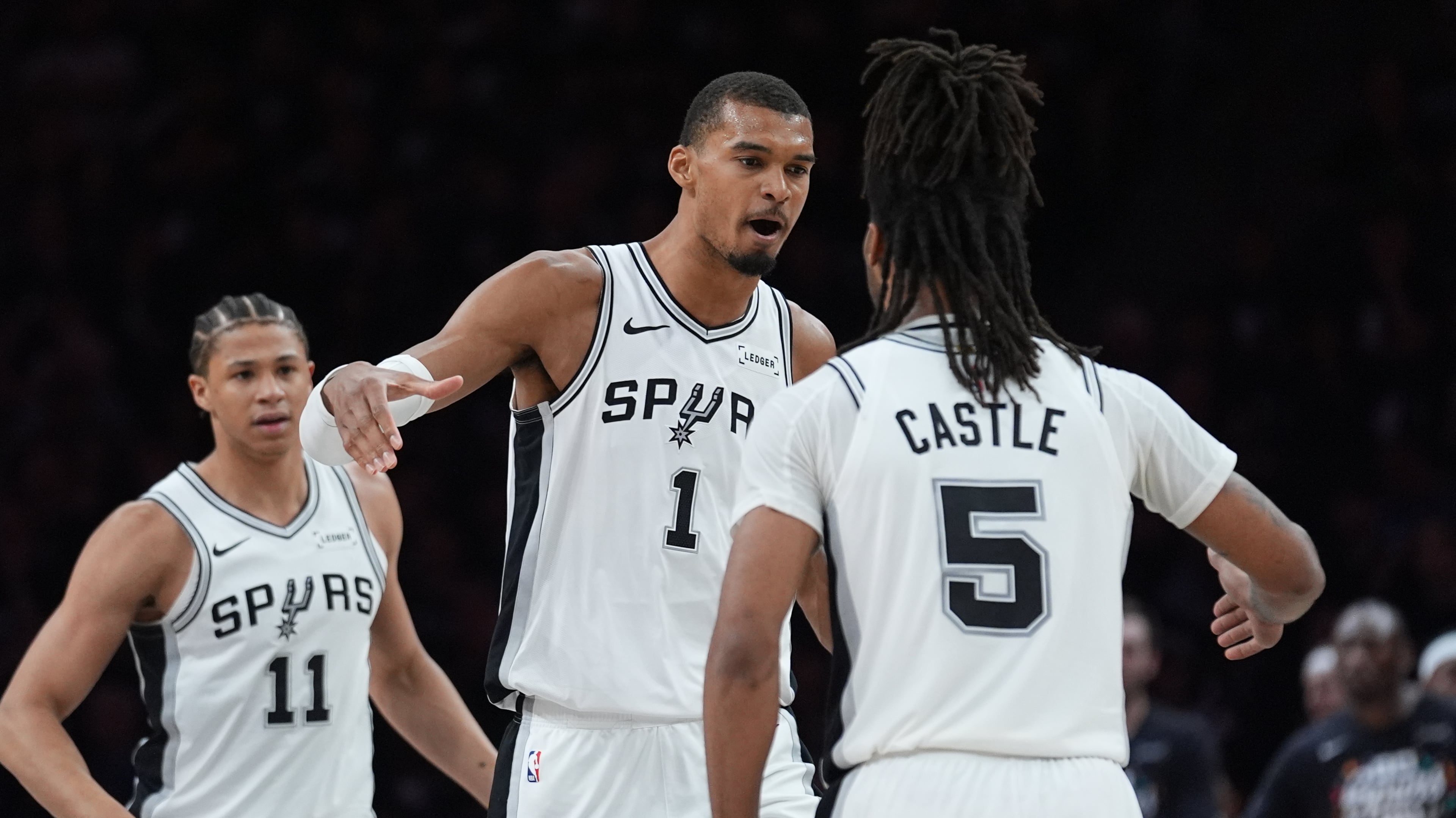 San Antonio Spurs forward Victor Wembanyama (1) celebrates a score with guard Stephon Castle (5) during the first half of Game 6 of an NBA basketball second-round playoffs series in Minneapolis, Friday, May 15, 2026. (AP Photo/Abbie Parr)