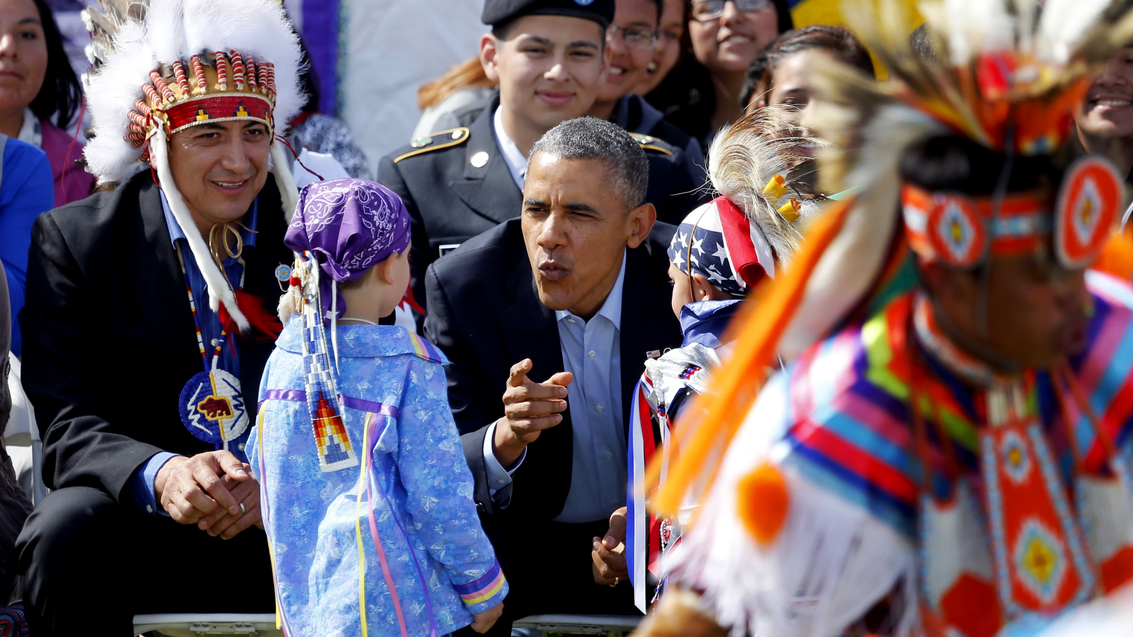 FILE - President Barack Obama talks to two young boys during a Native American dance on the Standing Rock Indian Reservation Friday, June 13, 2014, photo in Cannon Ball, N.D. (AP Photo/Charles Rex Arbogast,File)