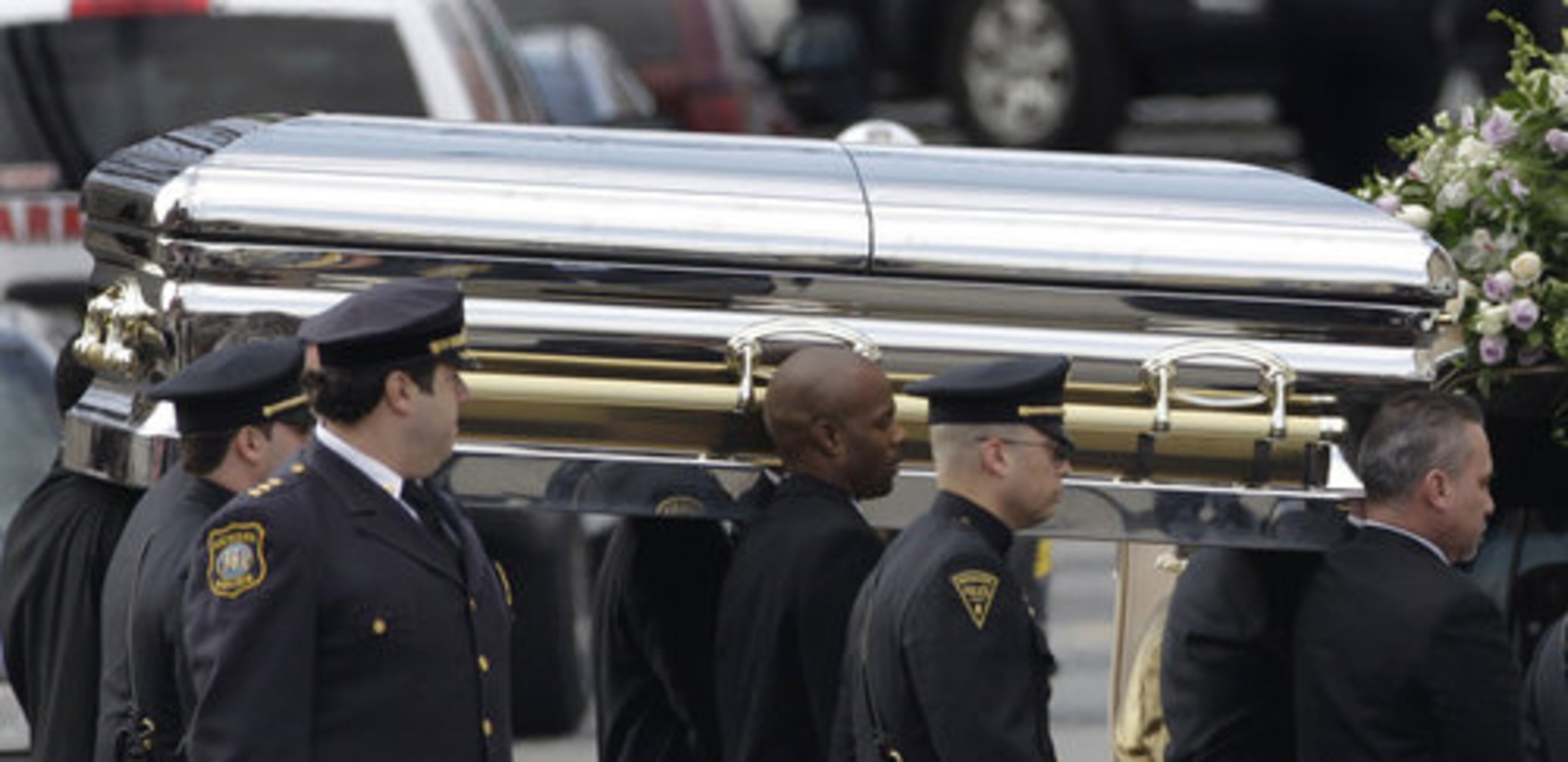 The coffin holding the remains of singer Whitney Houston is carried to a hearse after funeral services at the New Hope Baptist Church in Newark, N.J., Saturday, Feb. 18, 2012.