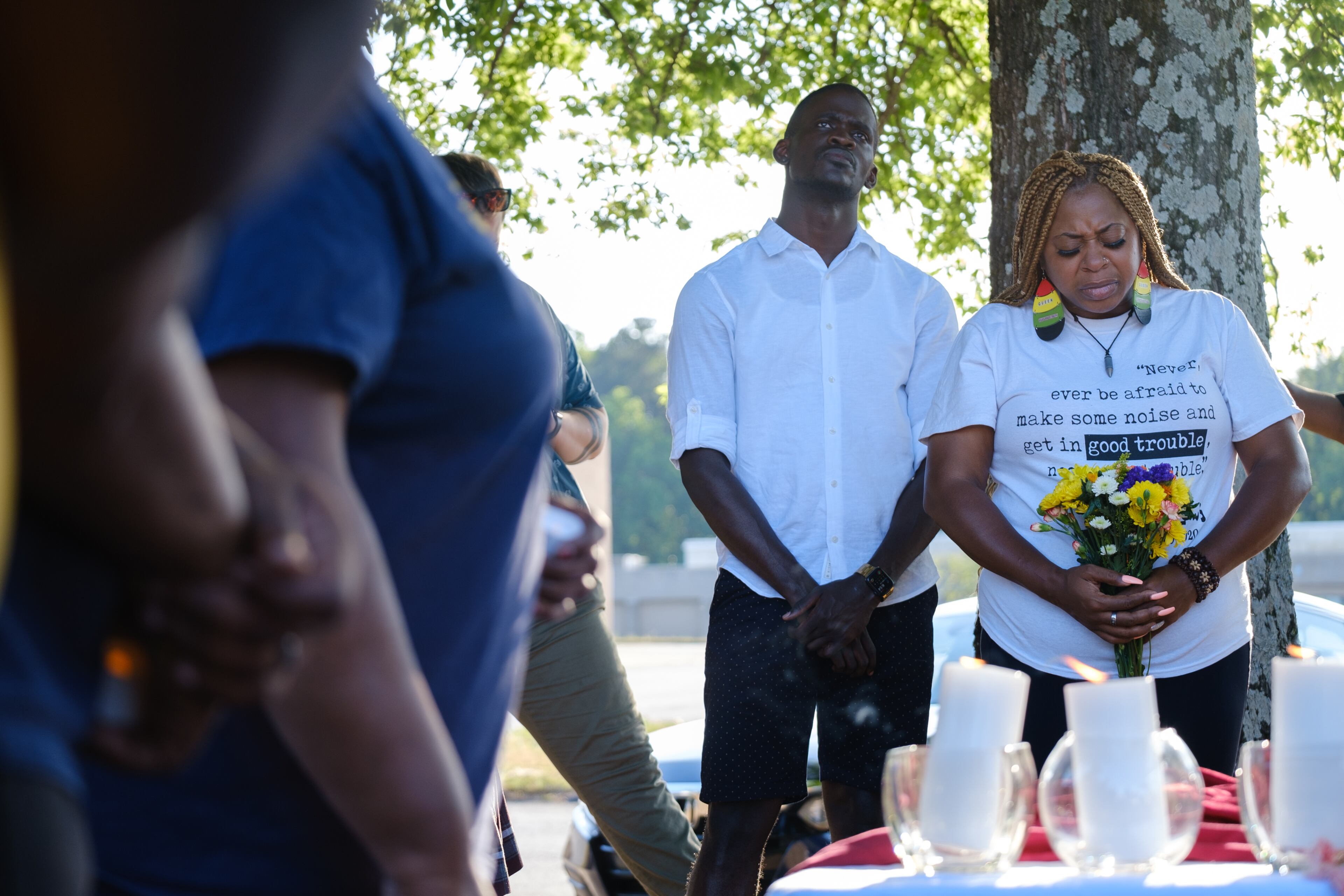 Community organizer Porch’se Miller (right), who grew up in Buffalo, praysl at a vigil at Big Bear Supermarket in Decatur on Tuesday, May 17, 2022. The vigil is honor of the 10 people killed at Tops Friendly Market grocery store in Buffalo, New York on May 14. (Arvin Temkar / arvin.temkar@ajc.com)