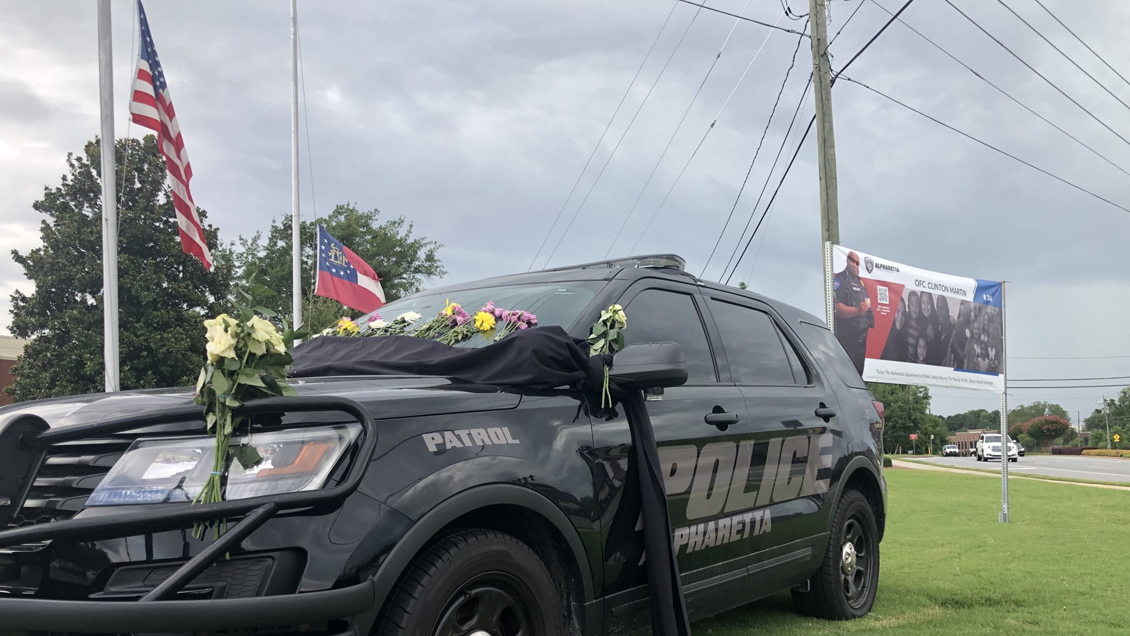 Clinton Martin was a beloved officer, colleagues say. Following his death, police placed his patrol car in front of the Alpharetta Department of Public Safety building and adorned it with photos and memories from fellow officers. Courtesy Alpharetta Department of Public Safety Facebook