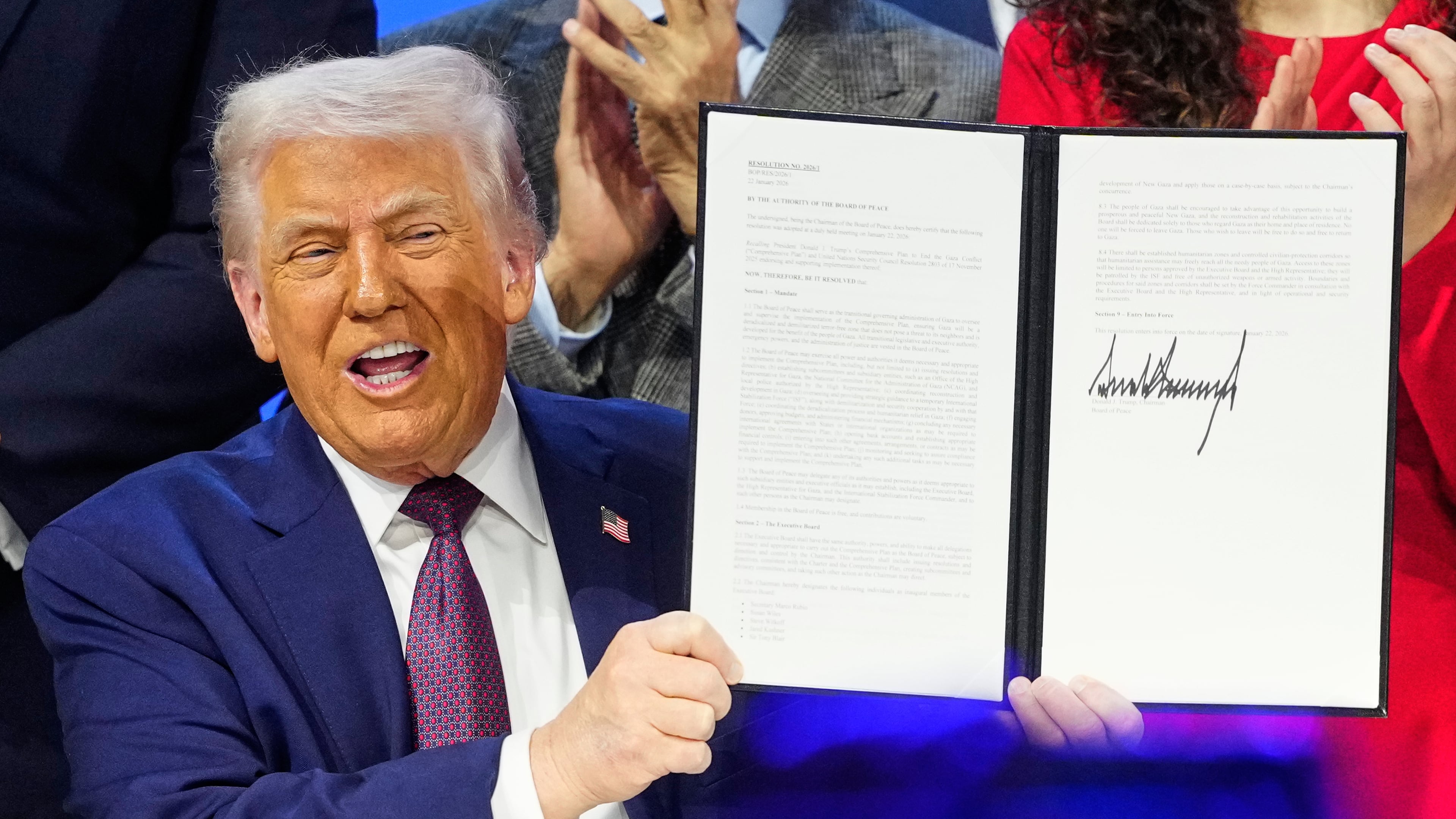 President Donald Trump holds the charter during a signing ceremony on his Board of Peace initiative at the Annual Meeting of the World Economic Forum in Davos, Switzerland, Thursday, Jan. 22, 2026. (AP Photo/Markus Schreiber)
