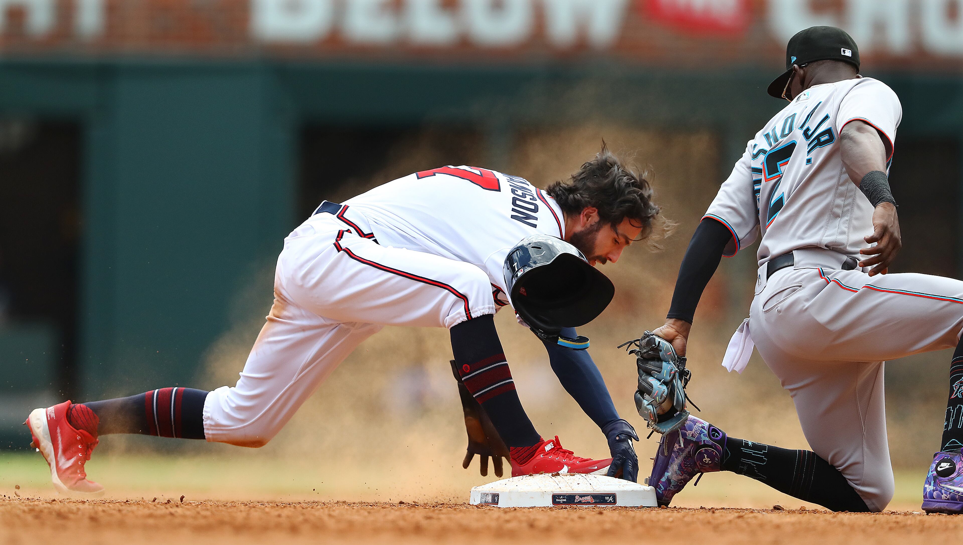 Atlanta Braves shortstop Dansby Swanson steals second past Miami Marlins second baseman Jazz Chisholm Jr. during the fifth inning of a MLB baseball game on Sunday, May 29, 2022, in Atlanta. Swanson went on to steal third and then score on RBI double by Austin Riley for a 5-1 lead. “Curtis Compton / Curtis.Compton@ajc.com”