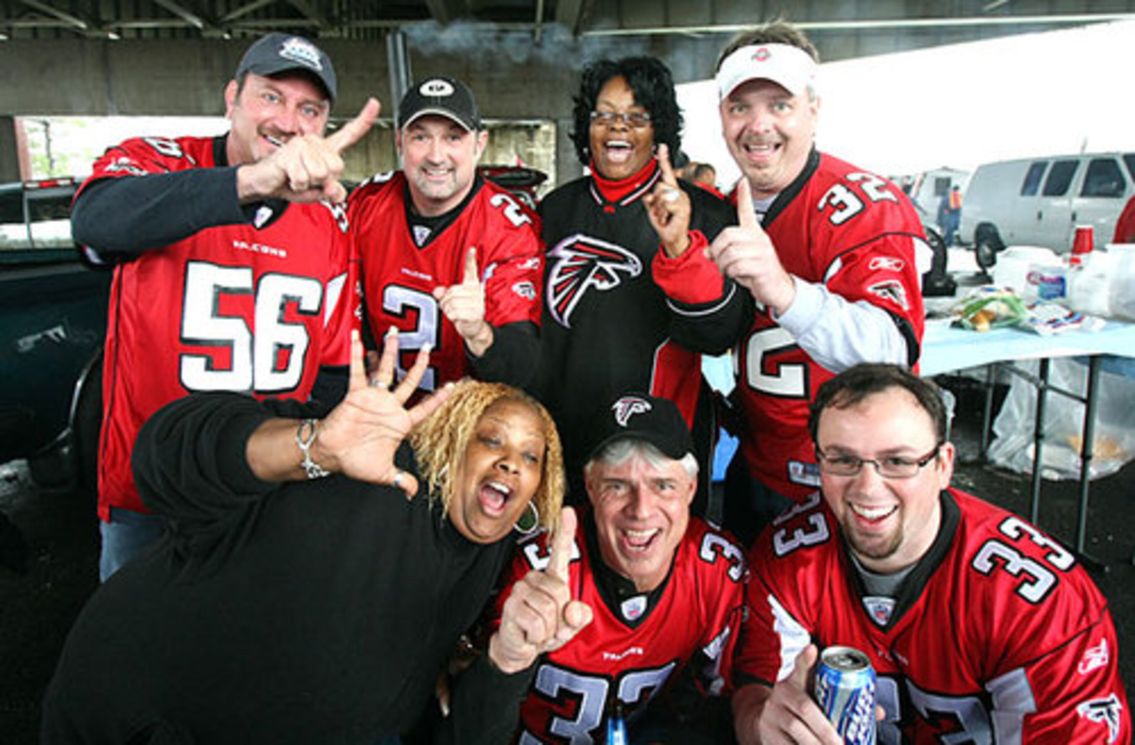 Falcons fans, clockwise from back left, David Bruce, Keith Sumner, Pat Dogan, Carl Zigler, Sam Low, Jeff Brookshire, and Rosa Bell gather for a group photo before Sunday's game.