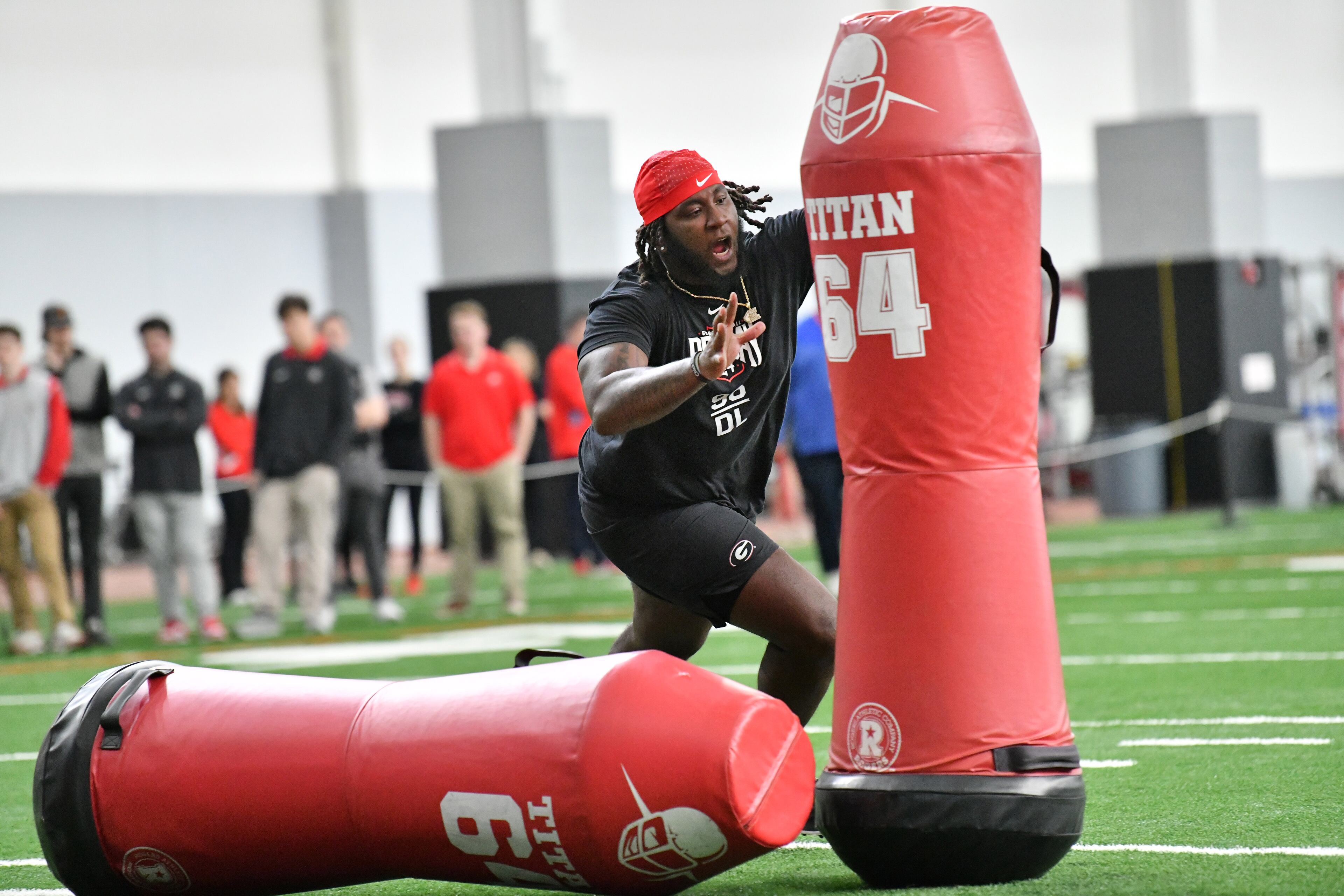 Georgia defensive lineman Zion Logue runs a hitting drill in front of coaches and scouts during Georgia Pro Day at Payne Indoor Athletic Facility, Wednesday, Mar. 13, 2024, in Athens. (Hyosub Shin / Hyosub.Shin@ajc.com)