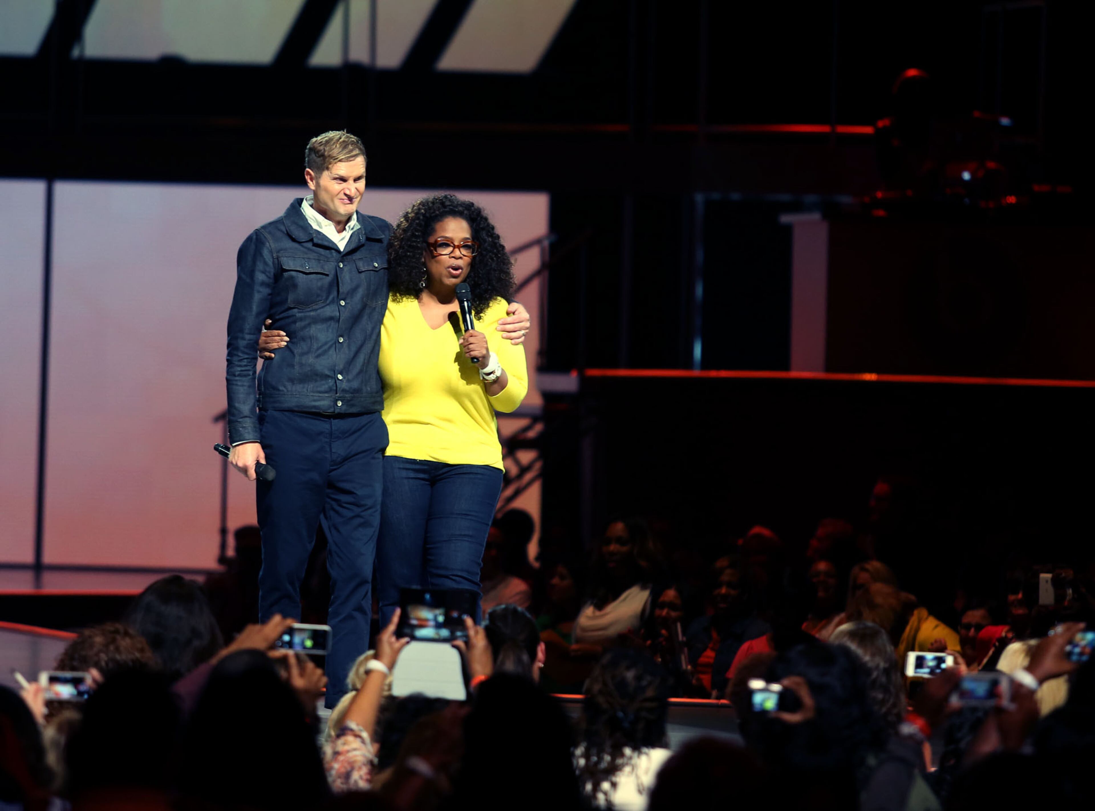 Pastor Rob Bell stands with Oprah Winfrey following his talk on "Everything is Spiritual" at Winfrey's "The Life You Want Weekend" tour in Atlanta on Saturday, Sept. 6, 2014. He is the author of several best-selling books, such as "What We Talk About When We Talk About God." (Akili-Casundria Ramsess/Special to the AJC)