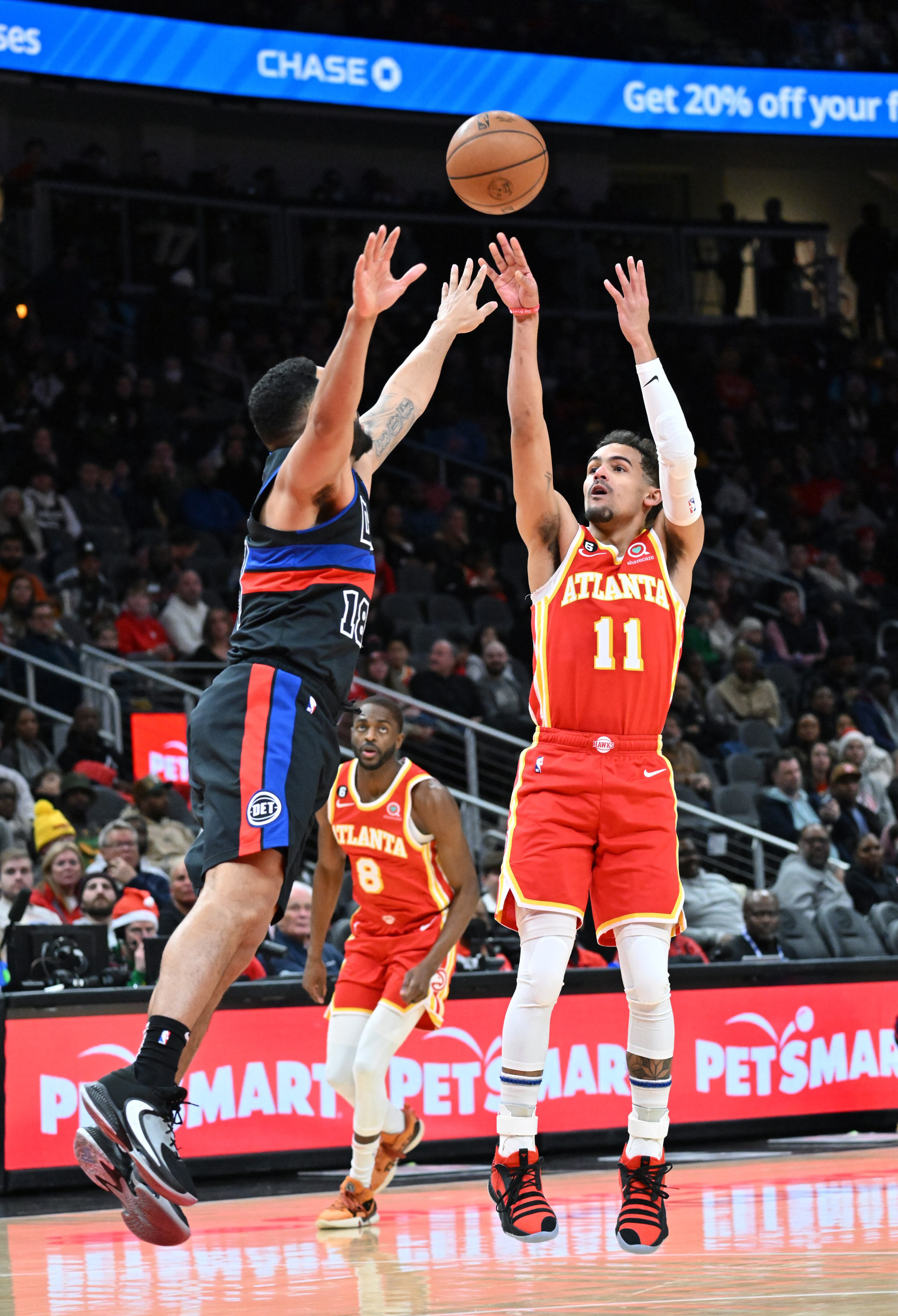 December 23, 2022 Atlanta - Atlanta Hawks' guard Trae Young (11) shoots over Detroit Pistons' guard Cory Joseph (18) during the first half in an NBA basketball game at State Farm Arena on Friday, December 23, 2022. (Hyosub Shin / Hyosub.Shin@ajc.com)