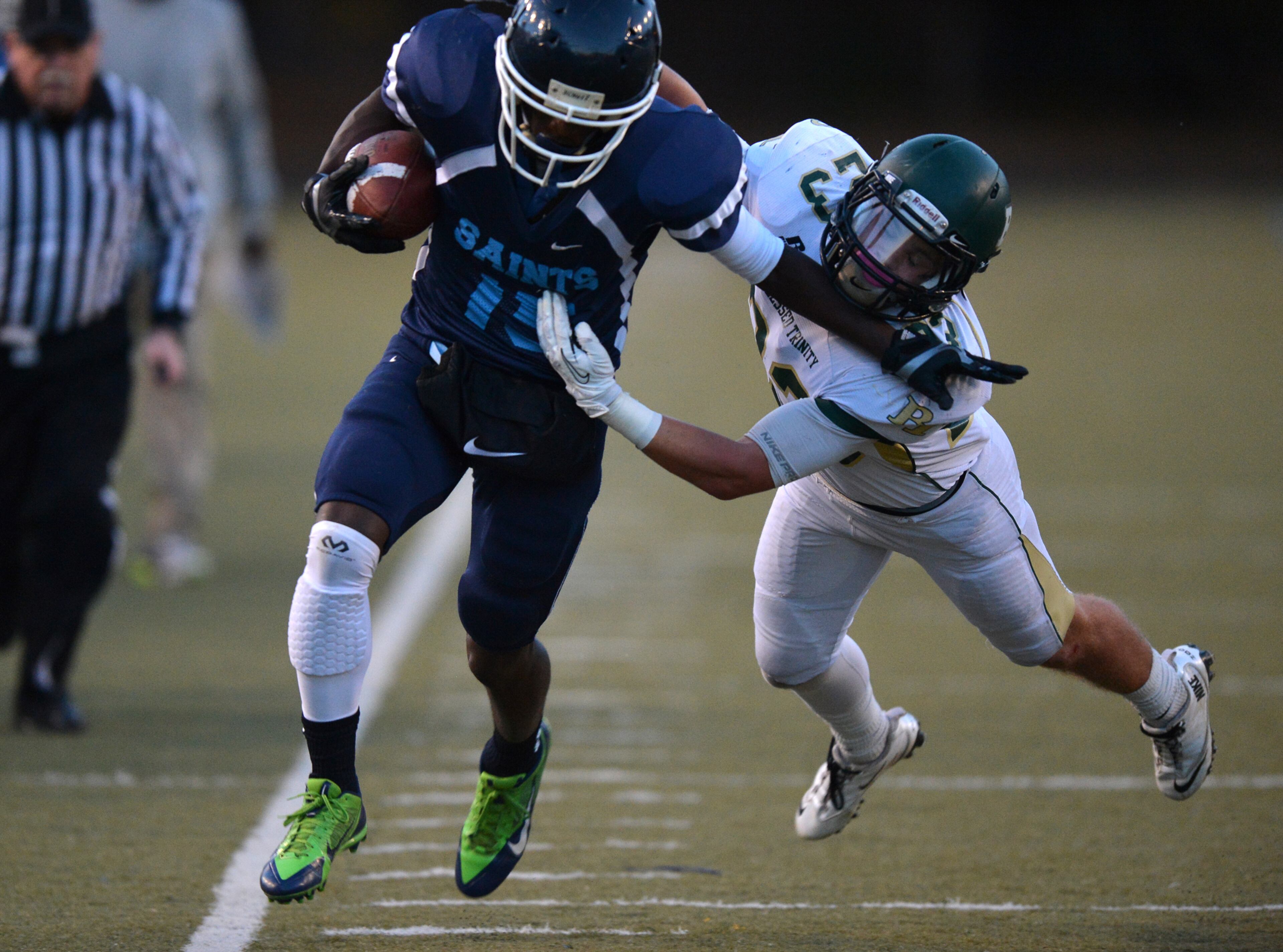 Cedar Grove receiver Brandon Norwood is pushed out of bounds by Blessed Trinity Kyle Evans during the first half at Hallford Stadium Friday November 8, 2013.