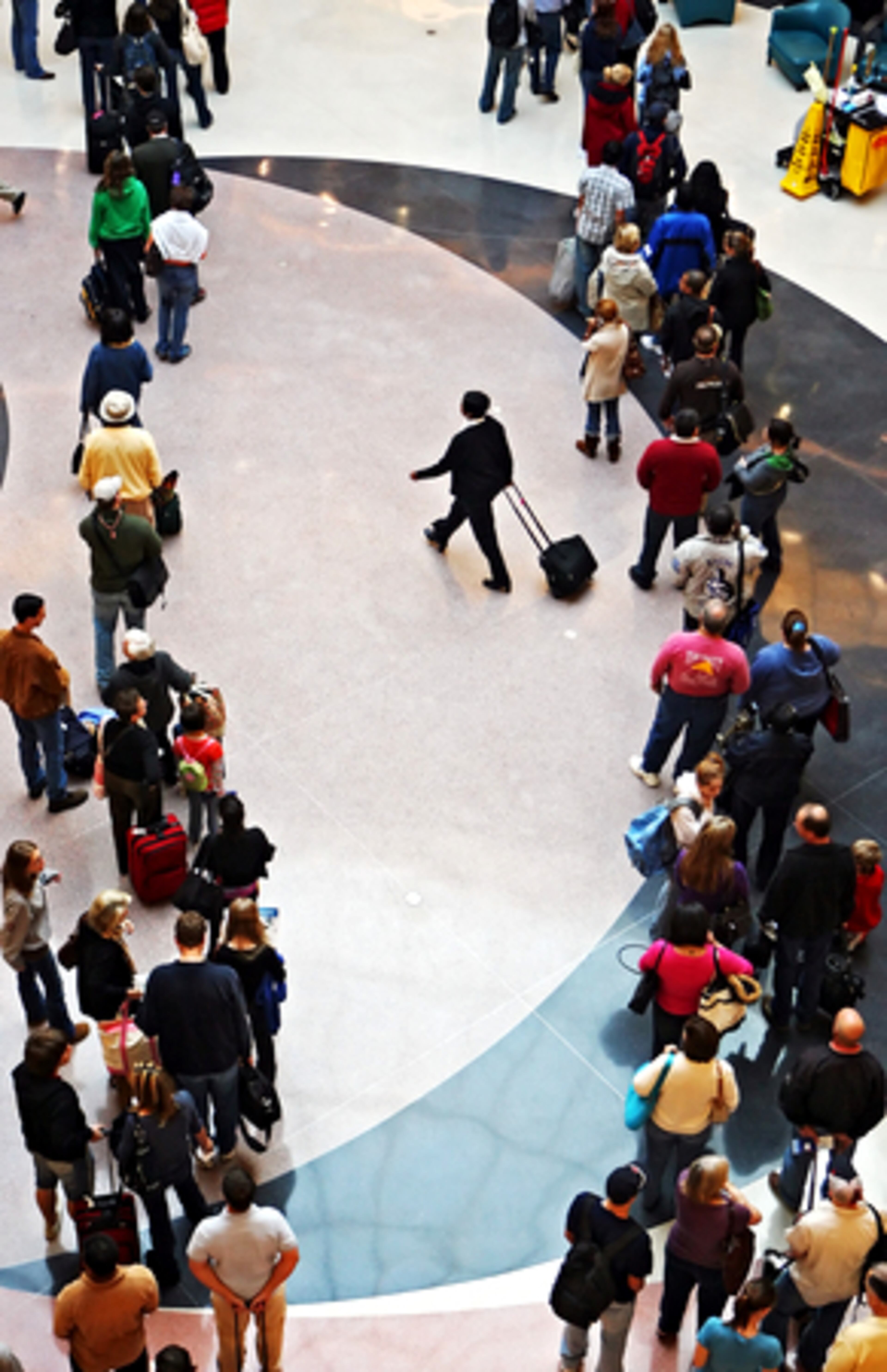 An airline employee weaves through two of the four massive lines that cut through the atrium at Hartsfield-Jackson on Wednesday morning.