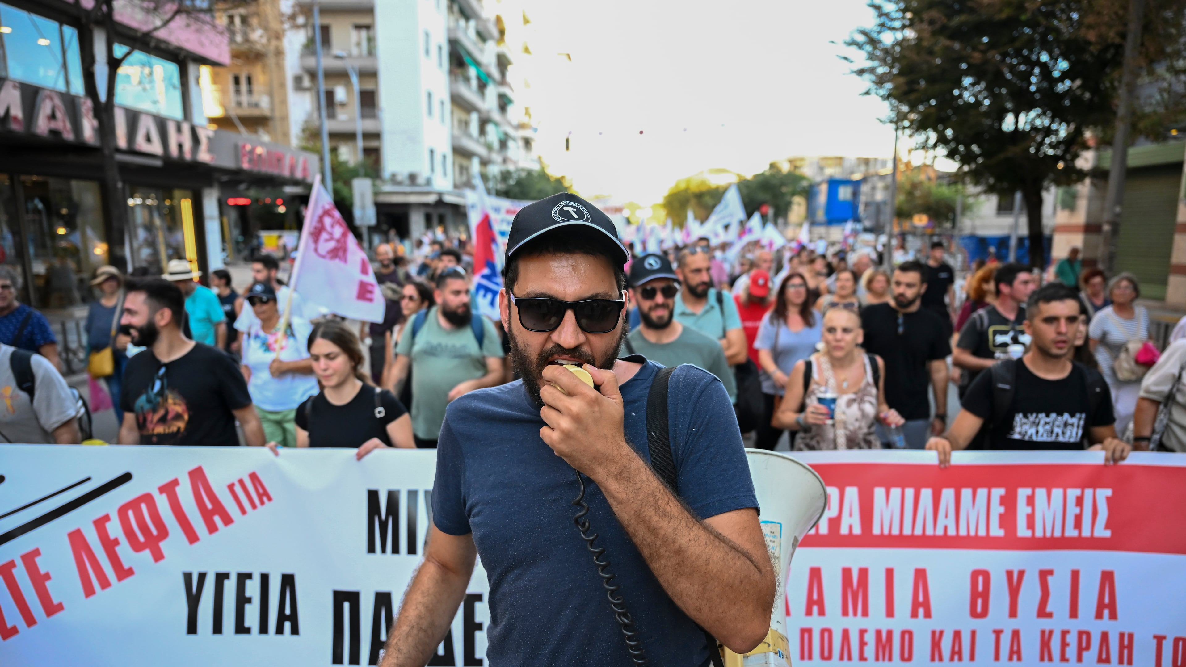 A protester shouts slogans with a megaphone during a protest rally near Thessaloniki's international trade fair, in the northern city of Thessaloniki, Greece, Saturday, Sept. 5, 2026. (AP Photo/Giannis Papanikos)