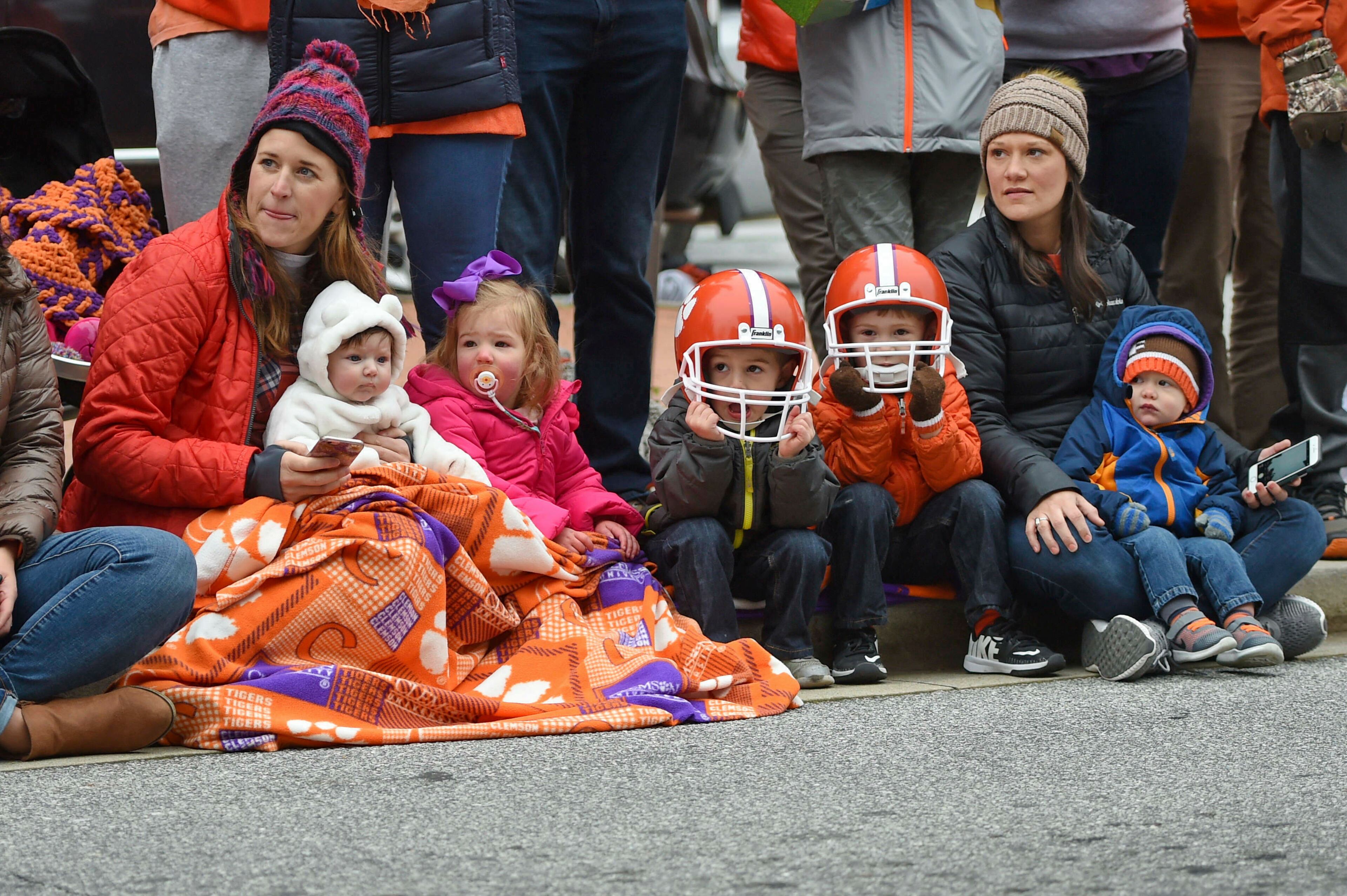 A family enjoys the parade held in Clemson's honor Saturday, Jan. 12, 2019, in Clemson, S.C., TheTigers defeated Alabama 44-16 in the College Football Playoff championship game Monday Jan. 7. (AP Photo/Richard Shiro)