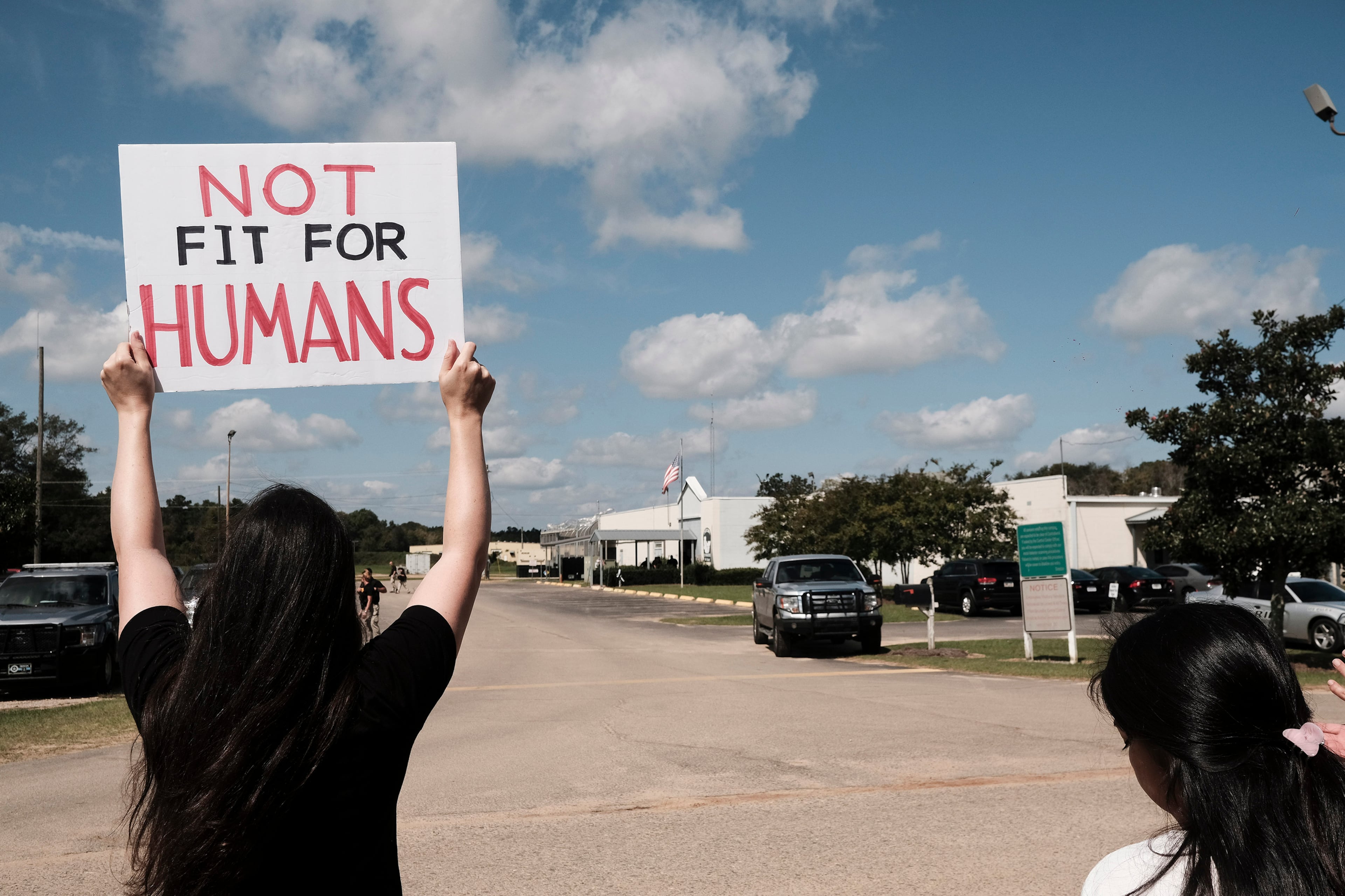 A protester holds a sign saying "Not Fit for Humans" during a demonstration in September 2020 outside the Irwin County Detention Center in Ocilla, Georgia. (John Arthur Brown/Zuma Press/TNS)