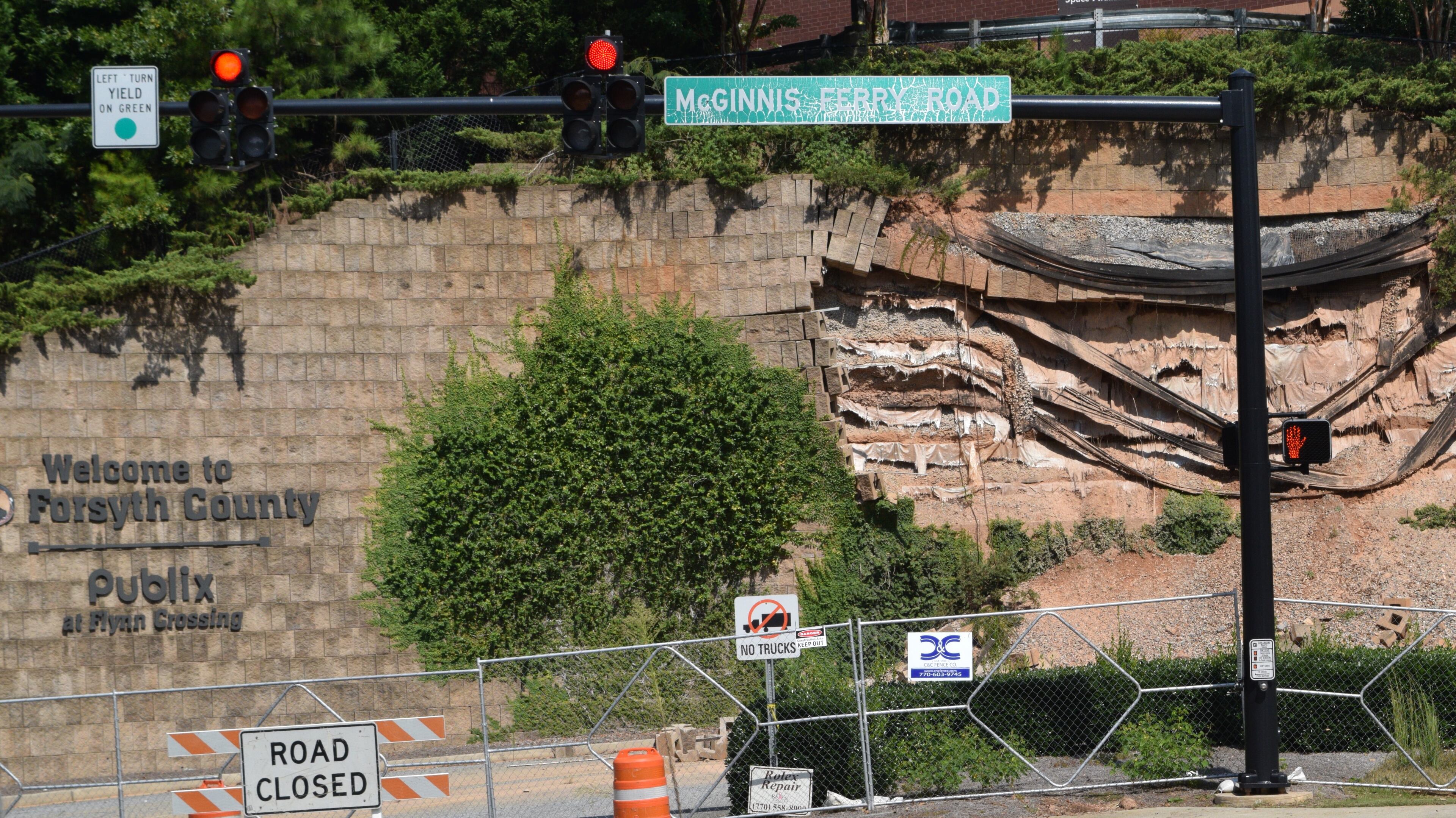 The collapsed wall at the intersection of McGinnis Ferry Road and Windward Parkway is on the way to be reconstructed and shoppers will no longer inconvenienced by the closure of a main access to a popular South Forsyth commercial area. Marty Farrell for the AJC