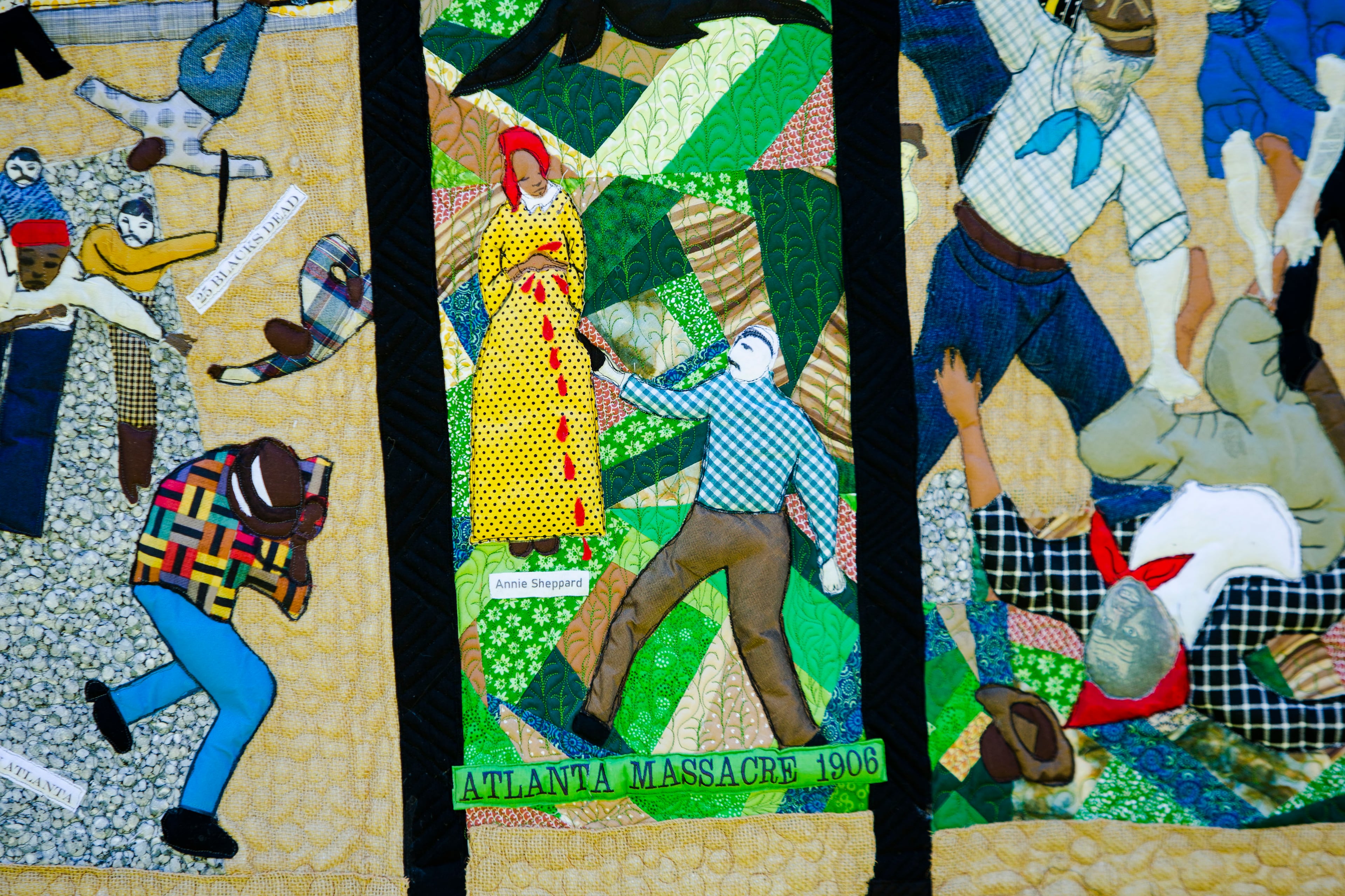 A detail is shown from a quilt illustrating the Atlanta Race Massacre during the dedication of a historical marker for Zeb Long, a lynching victim from the 1906 massacre, on Saturday, September 24, 2022, at Sumner Park in East Point. CHRISTINA MATACOTTA FOR THE ATLANTA JOURNAL-CONSTITUTION