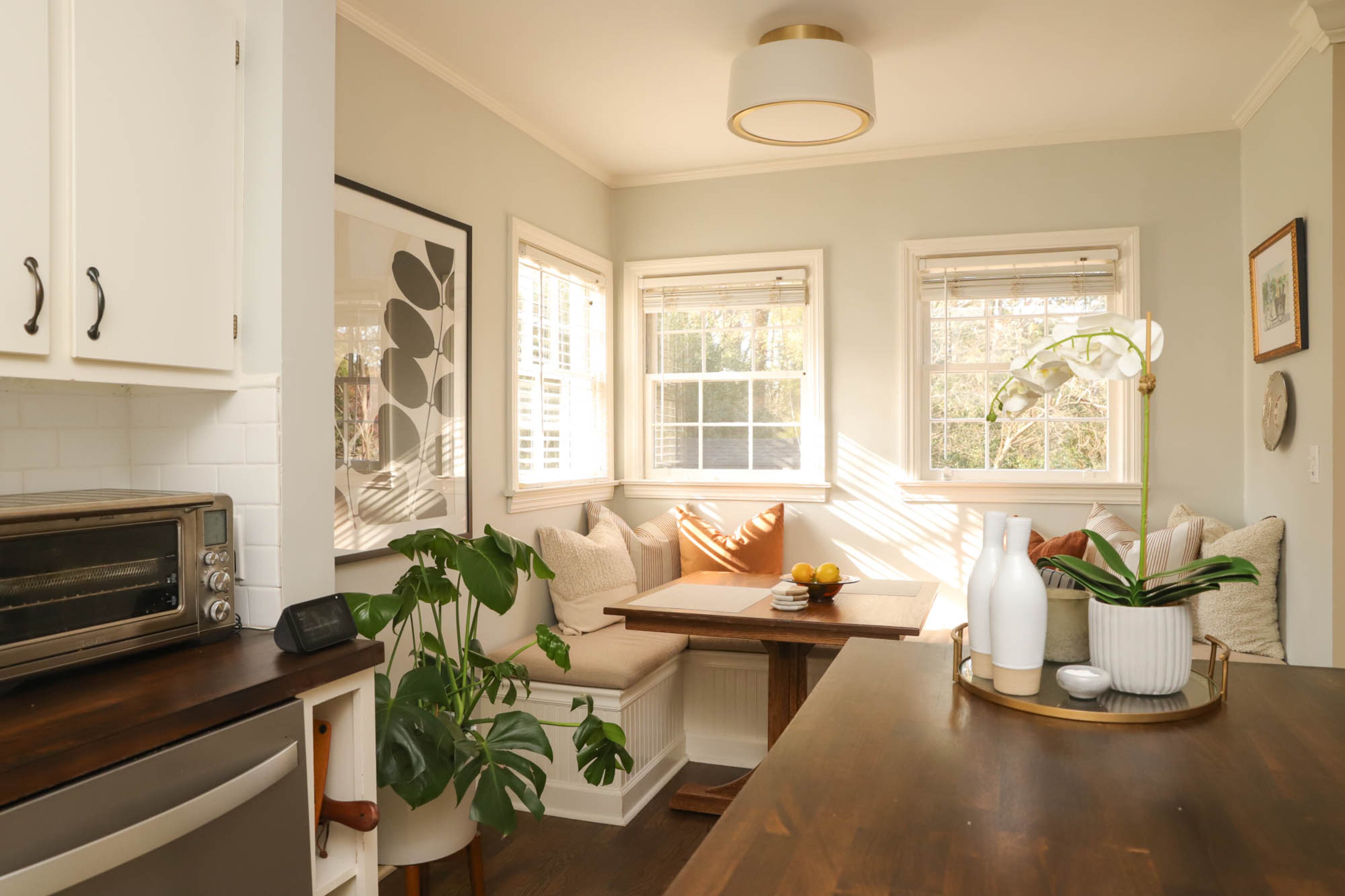 One of the coziest features of the house is this built-in breakfast nook, which Kerry Phillips notes was something a previous homeowner had added. Finding a table that would fit in the space proved to be a challenge until one of her husband’s woodworking relatives came through with a custom-built design for the couple. It’s one of the most special pieces in the home, Kerry says. Other built-in features of the home are the open storage cabinets under the counters that house items like cutting boards and cookbooks. Text by Lori Keong/Photo by Reynolds Rogers