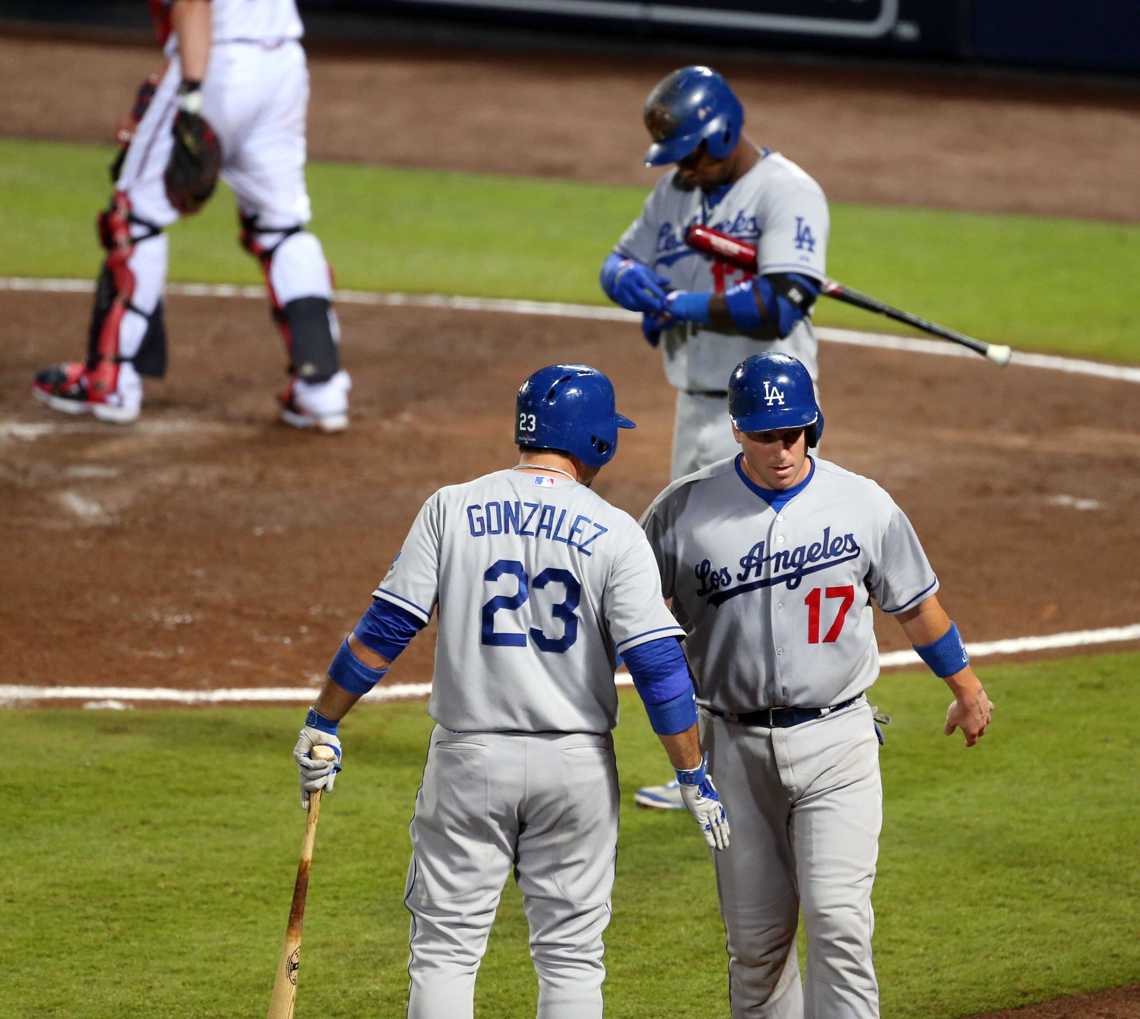 Los Angeles Dodgers first baseman Adrian Gonzalez (23)and Los Angeles Dodgers catcher A.J. Ellis (17) celebrate Ellis score in the 4th inning during the first game of the National League Division series between the Los Angeles Dodgers and Atlanta Braves at Turner Field, Thursday, October 3, 2013.