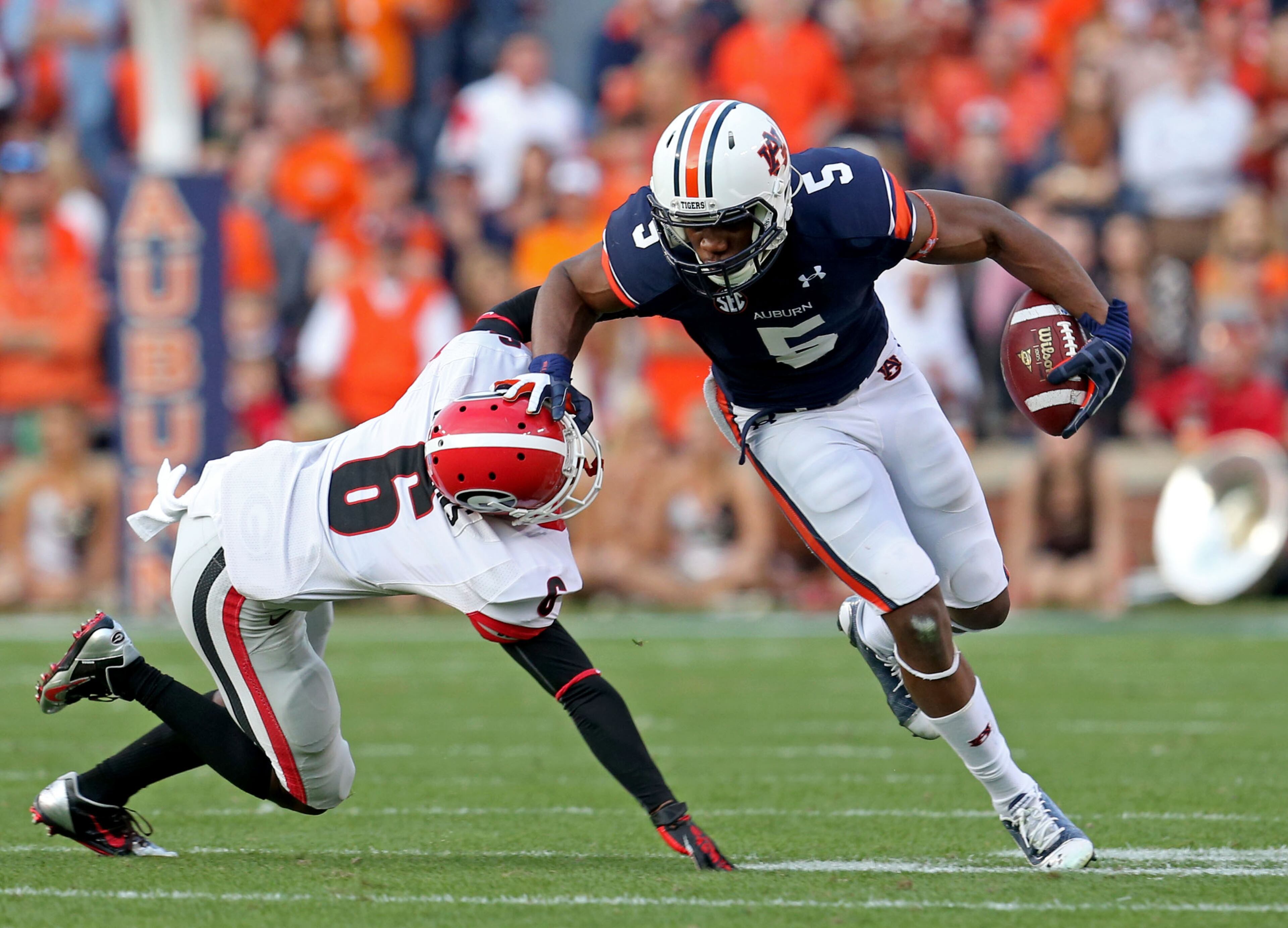 Auburn Tigers wide receiver Ricardo Louis (5) gets by the tackle of Georgia Bulldogs cornerback Shaq Wiggins (6) after a reception Auburn Tigers quarterback Nick Marshall in the first half of their game at Jordan-Hare Stadium Saturday afternoon in Auburn, Al., November 16, 2013.