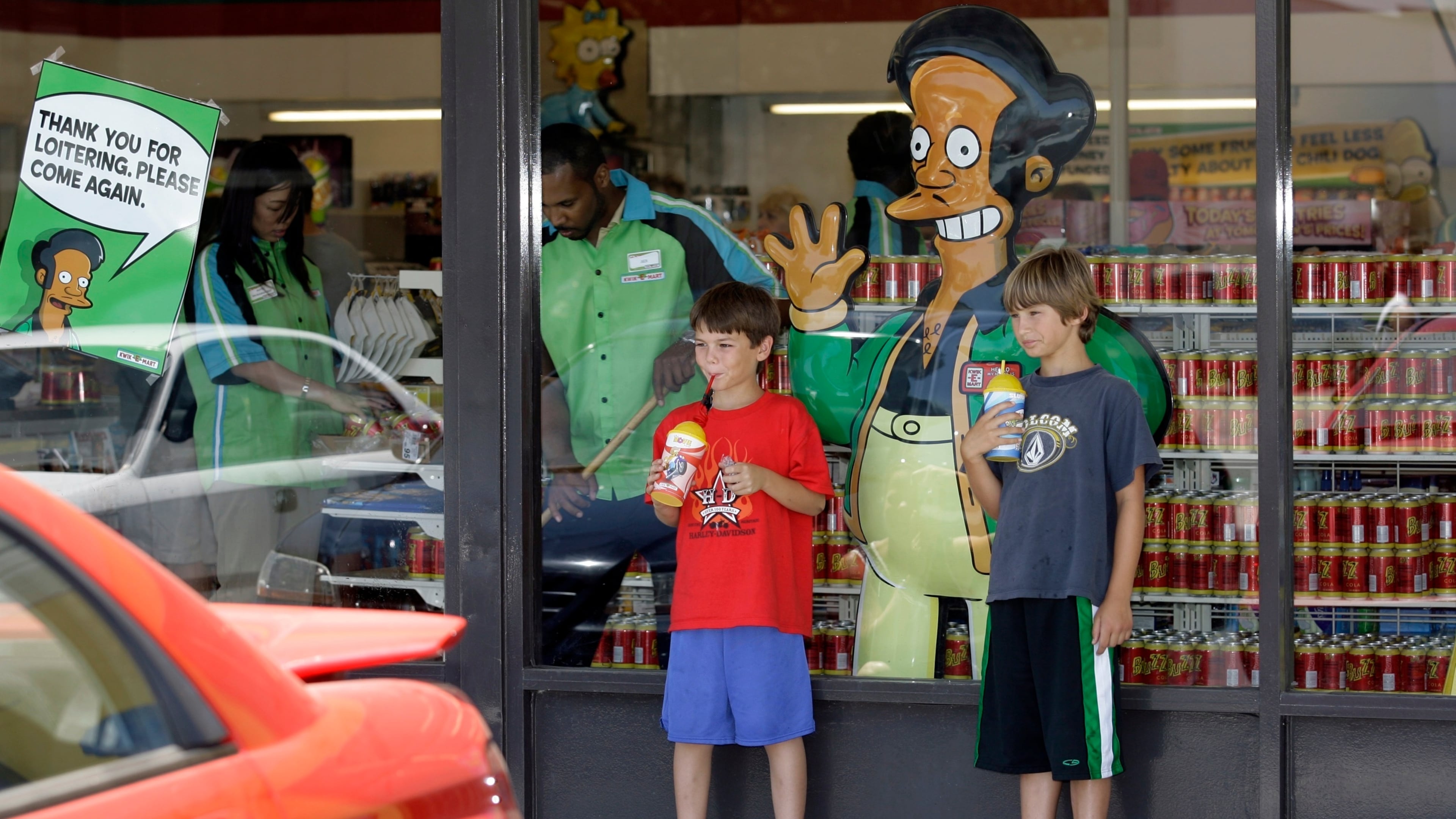 FILE - Children appear next to a window display featuring "The Simpsons" character Apu Nahasapeemapetilon Jr. outside a 7-Eleven Kwik-E-Mart in Burbank, Calif., on July 2, 2007. (AP Photo/Damian Dovarganes, File)