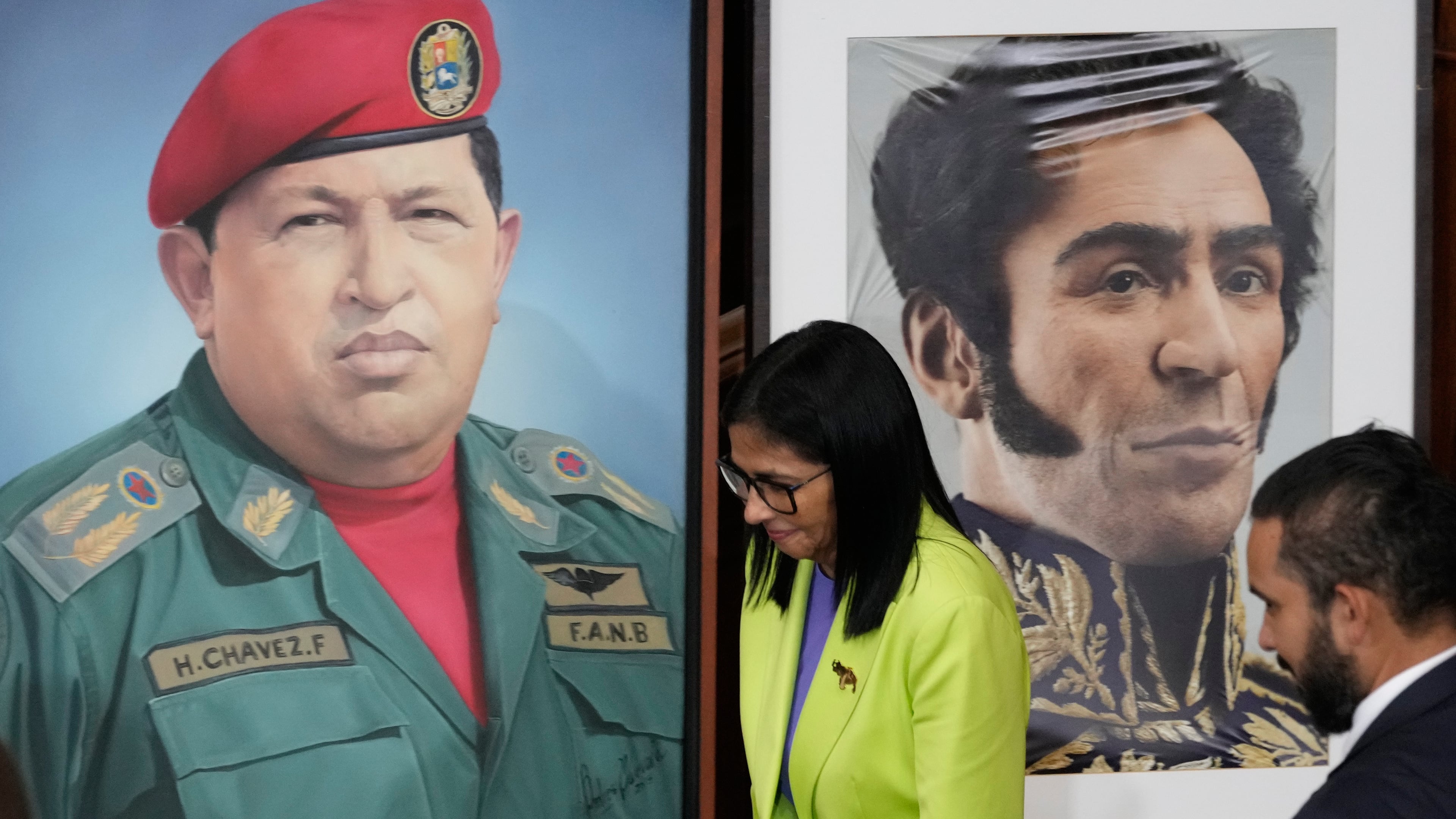 FILE - Venezuela's acting President Delcy Rodriguez walks past a image of former President Hugo Chavez, left, and Independence hero Simon Bolivar at the National Assembly in Caracas, Venezuela, Jan. 15, 2026. (AP Photo/Ariana Cubillos, File)