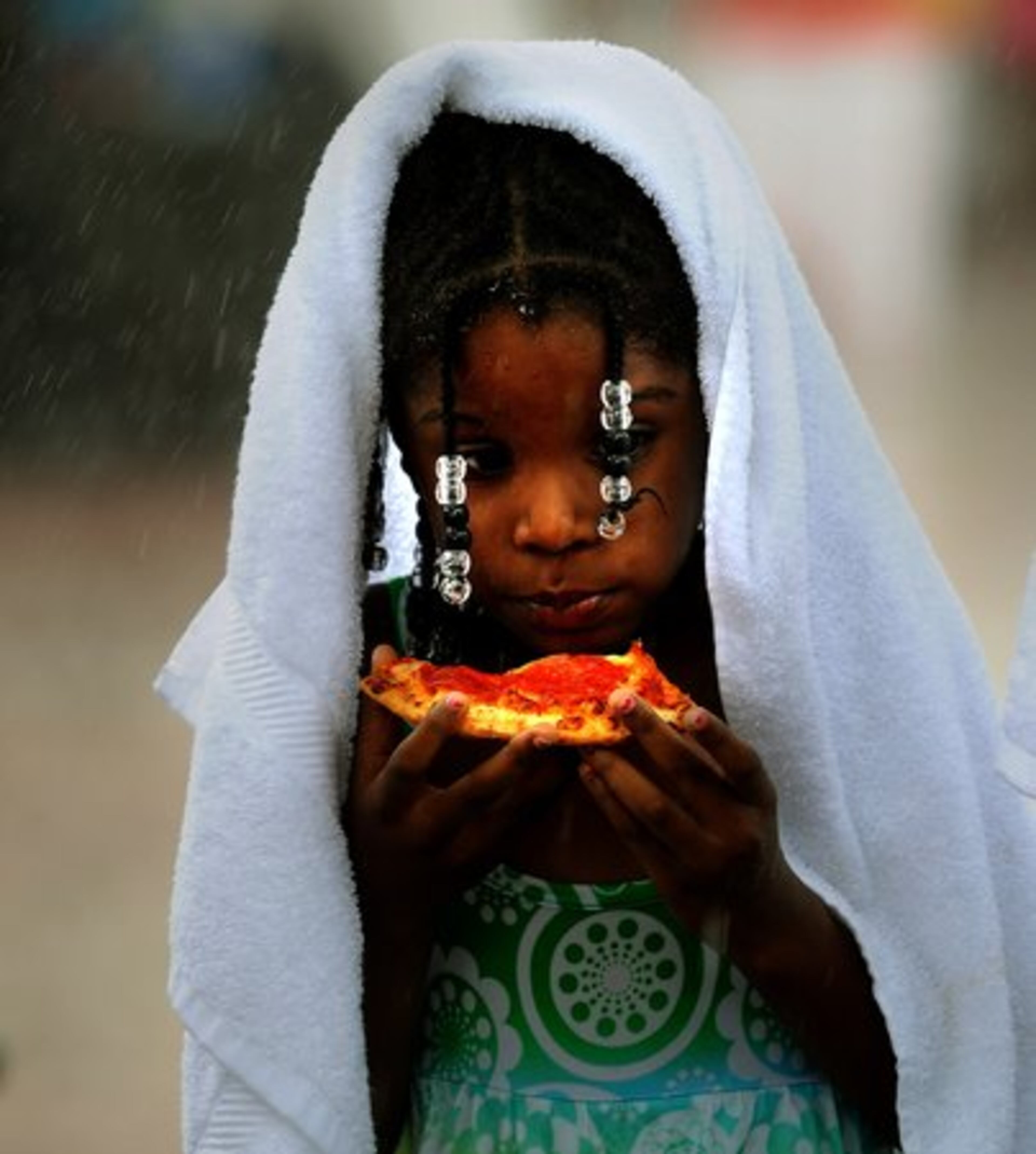 .... or six-year-old Kiyarah Carter of Lithonia, who continued to eat her pizza through the raindrops ....