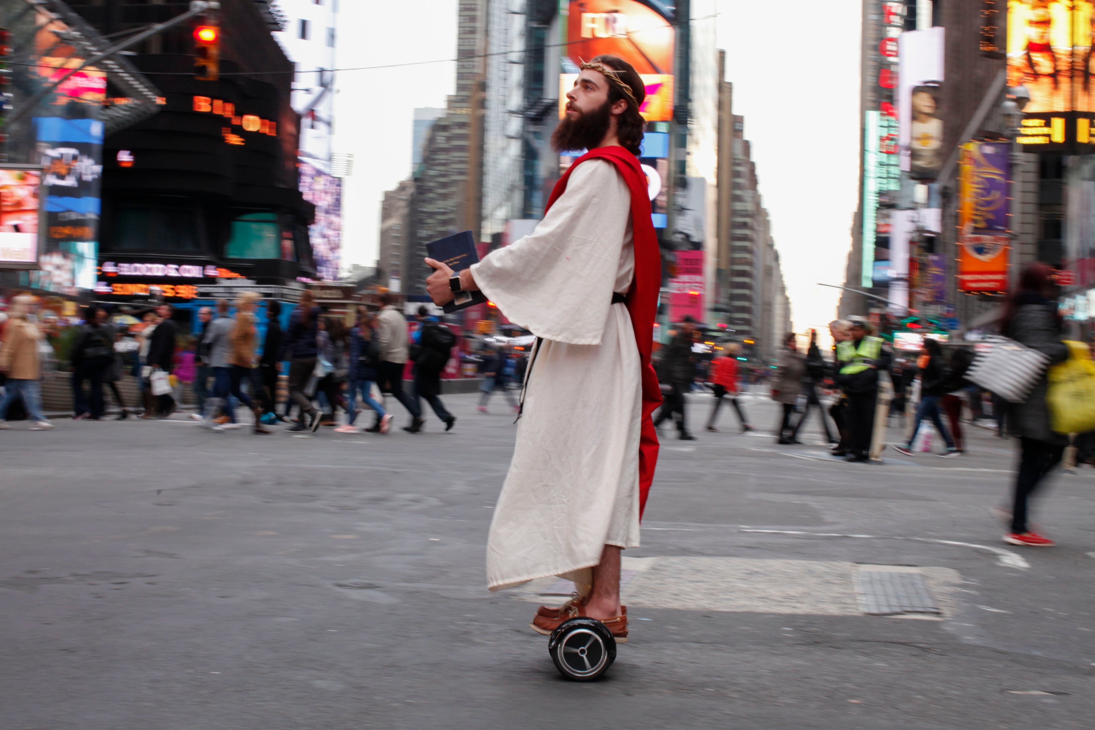 NEW YORK, NY - OCTOBER 31: A man dressed as Jesus Christ passes by on Times Square before the 42nd Annual Halloween Parade October 21, 2015 in New York City. (Photo by Kena Betancur/Getty Images)