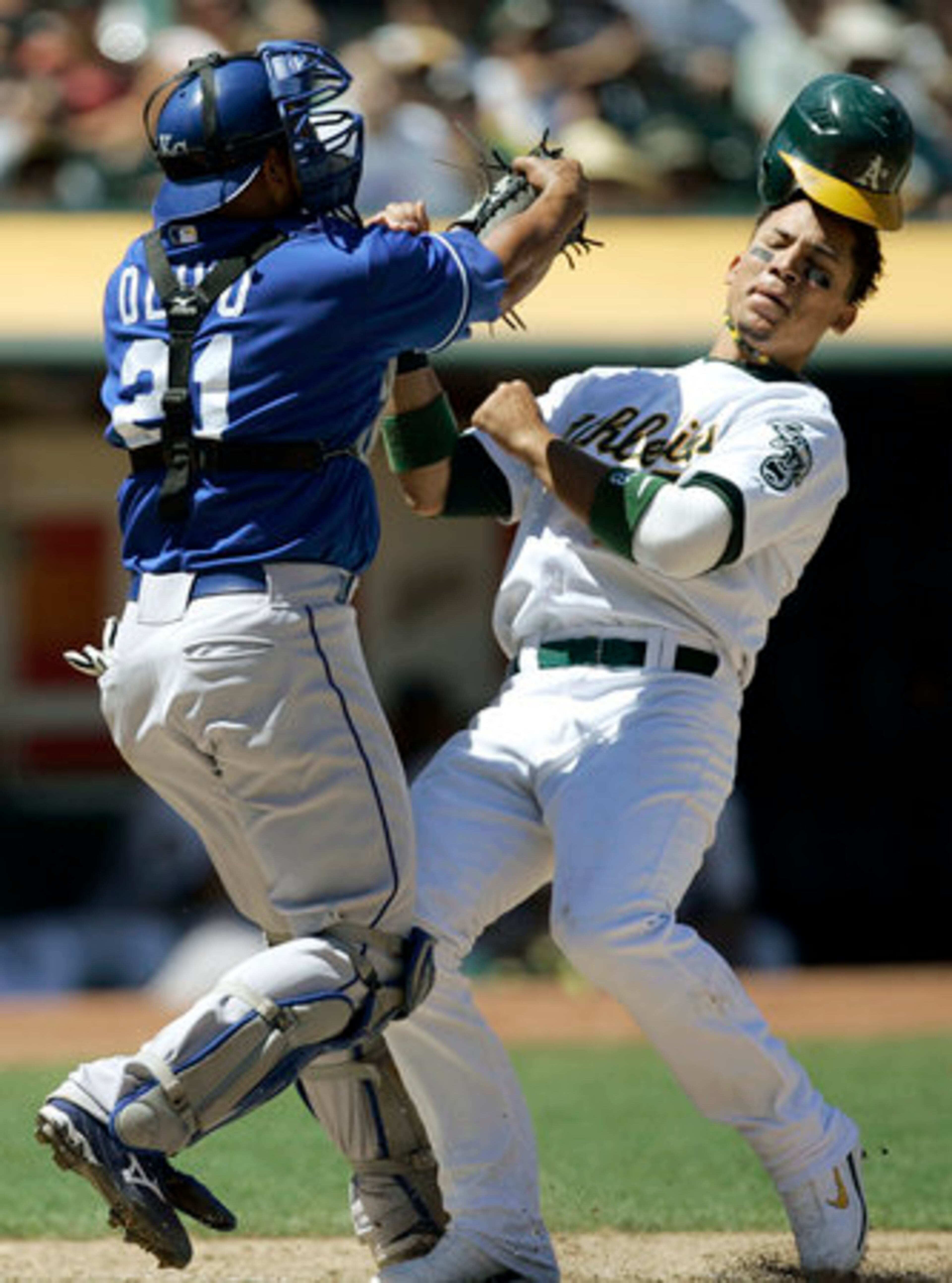 Kansas City Royals catcher Miguel Olivo tags out Oakland Athletics Carlos Gonzalez in Oakland, Calif. on Wednesday. Gonzalez attempted to score on a hit by Jack Cust.