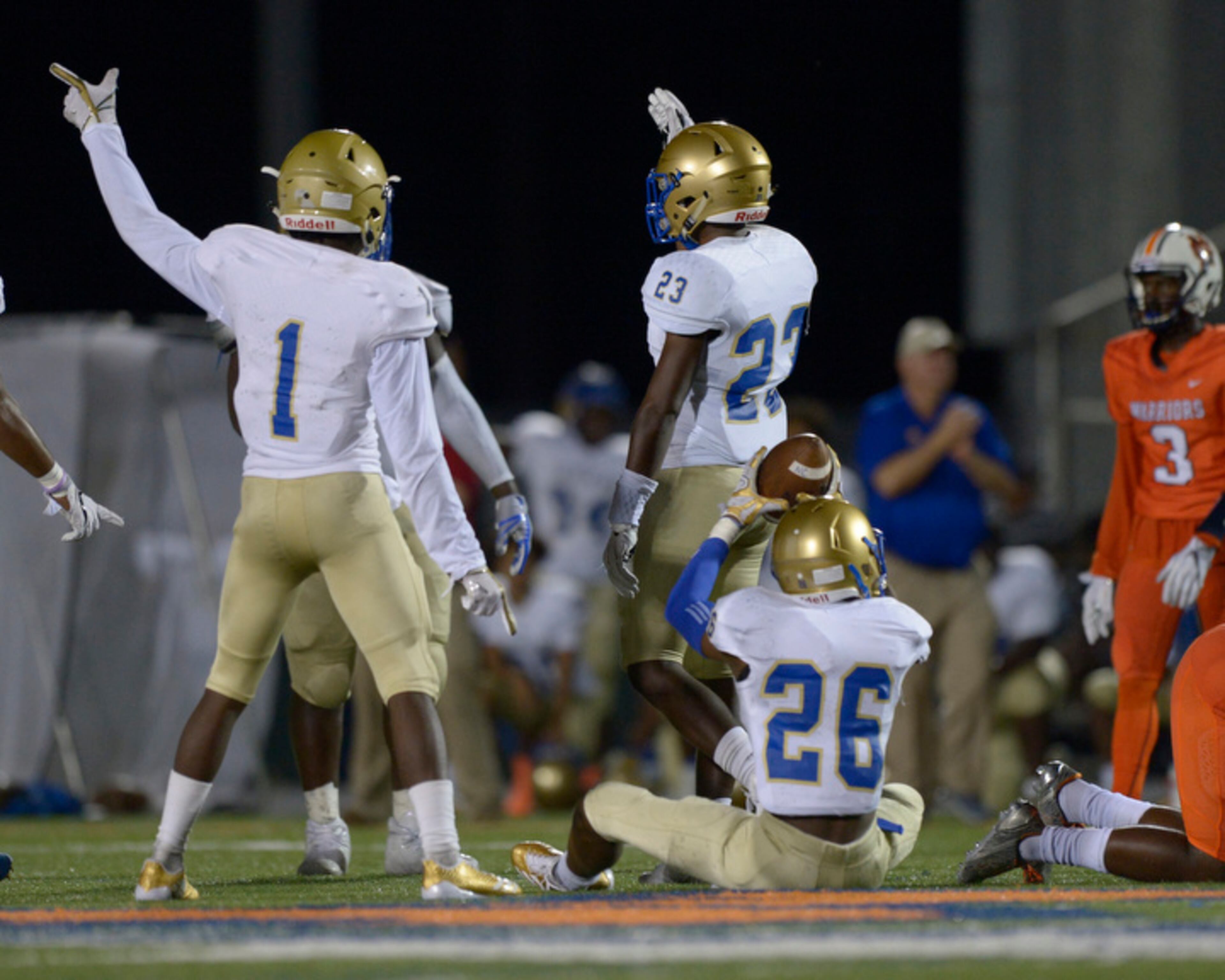Kennesaw, Ga. -- McEachern seniors Dwayne White Jr. (1) and Tony Davis (23) signal a McEachern possession along with junior Nate Dent (26) in the second half of their game at North Cobb Friday, October 6, 2017. Special/Daniel Varnado