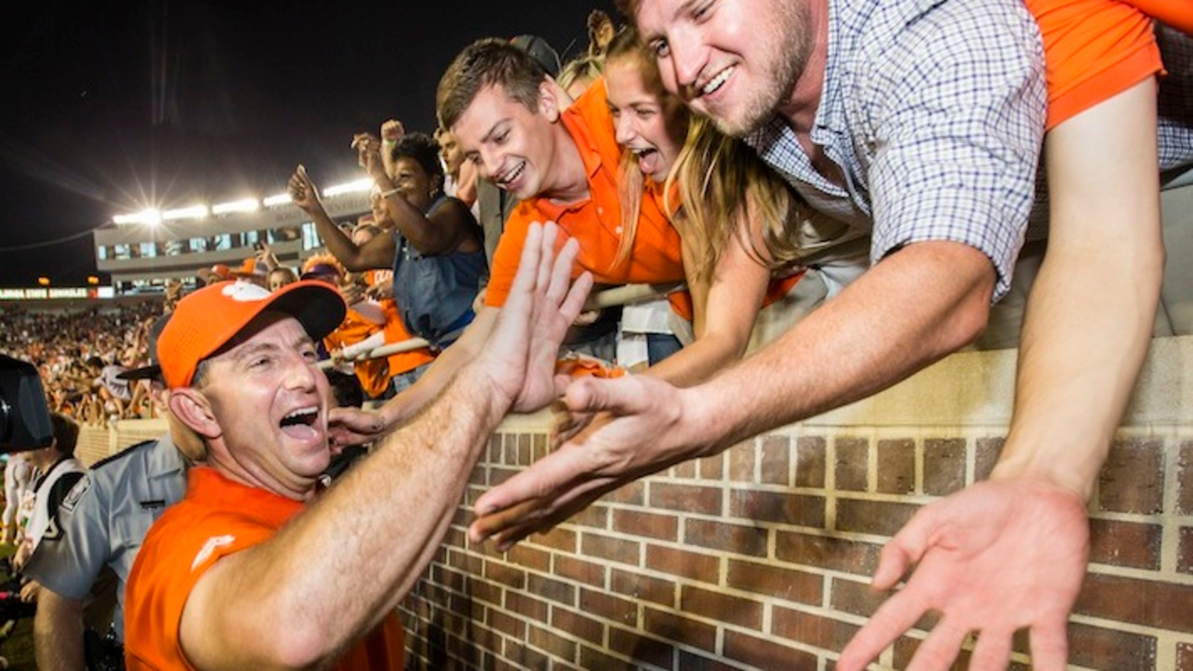 In this Saturday, Oct. 29, 2016, photo, Clemson coach Dabo Swinney celebrates the team's 37-34 win over Florida State in an NCAA college football game in Tallahassee, Fla. Not many college football fans outside of Alabama and Ohio State are totally content with their coach. And contentment can be fleeting as Michigan State fans are finding out now. These days Clemson fans are crazy about Swinney and Stanford supporters are cool with David Shaw. (AP Photo/Mark Wallheiser, File)