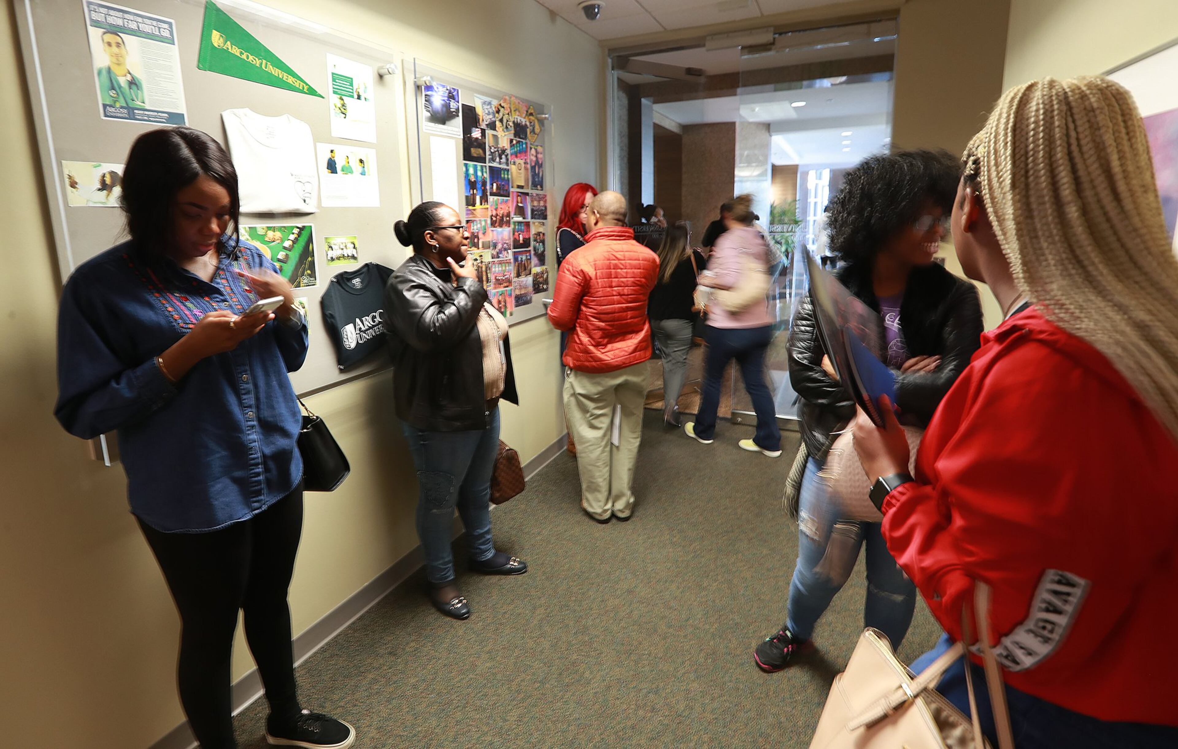 Argosy University students wait inside the Atlanta-area campus to find out information on the future of the school in this March 2019 photo. The university closed for good a couple of days later. CURTIS COMPTON / CCOMPTON@AJC.COM