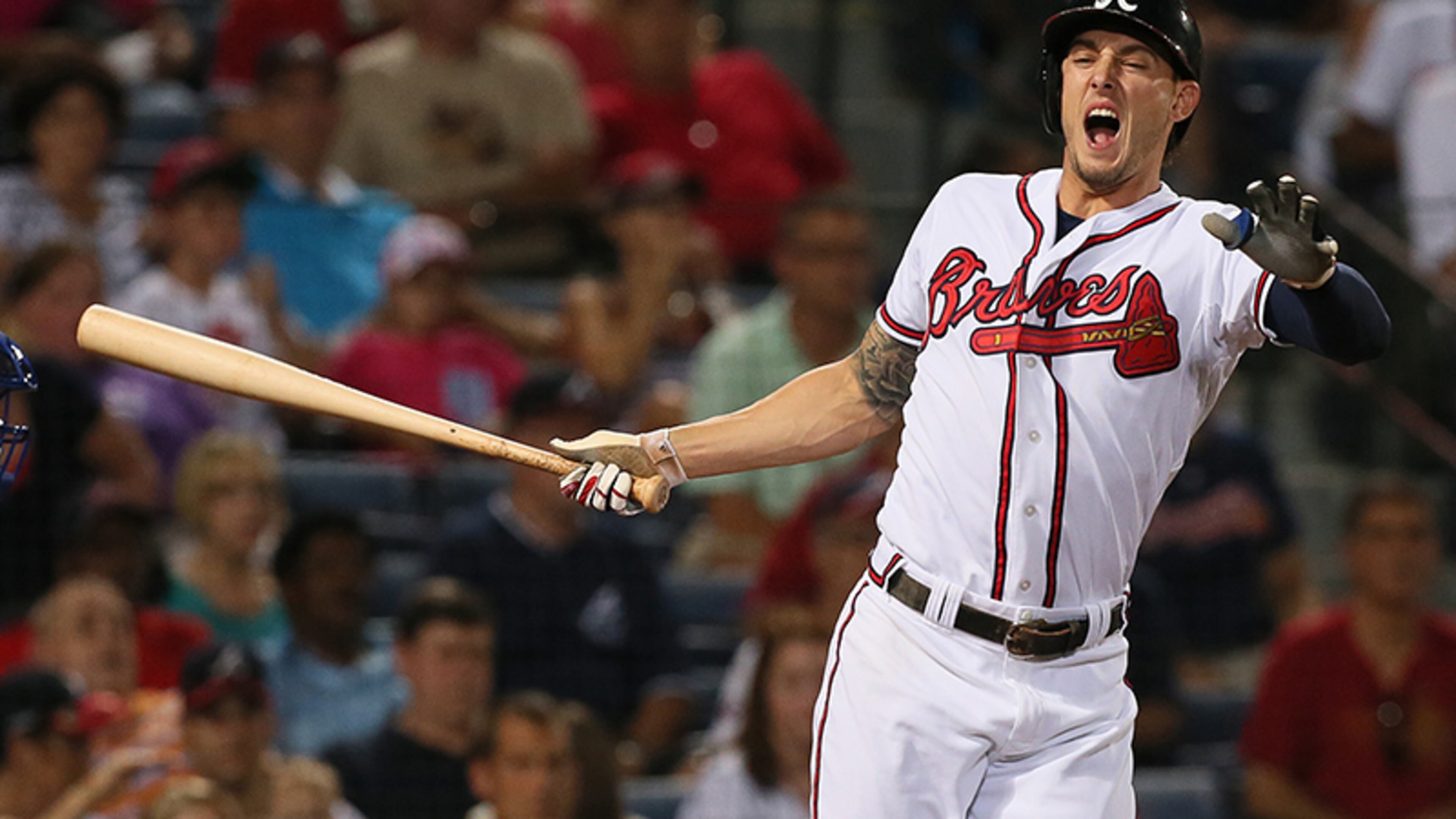 Jordan Schafer turns away from the plate after fouling a pitch off his foot during the 7th inning in Tuesday's game against the Mets at Turner Field. Schafer remained in the game.