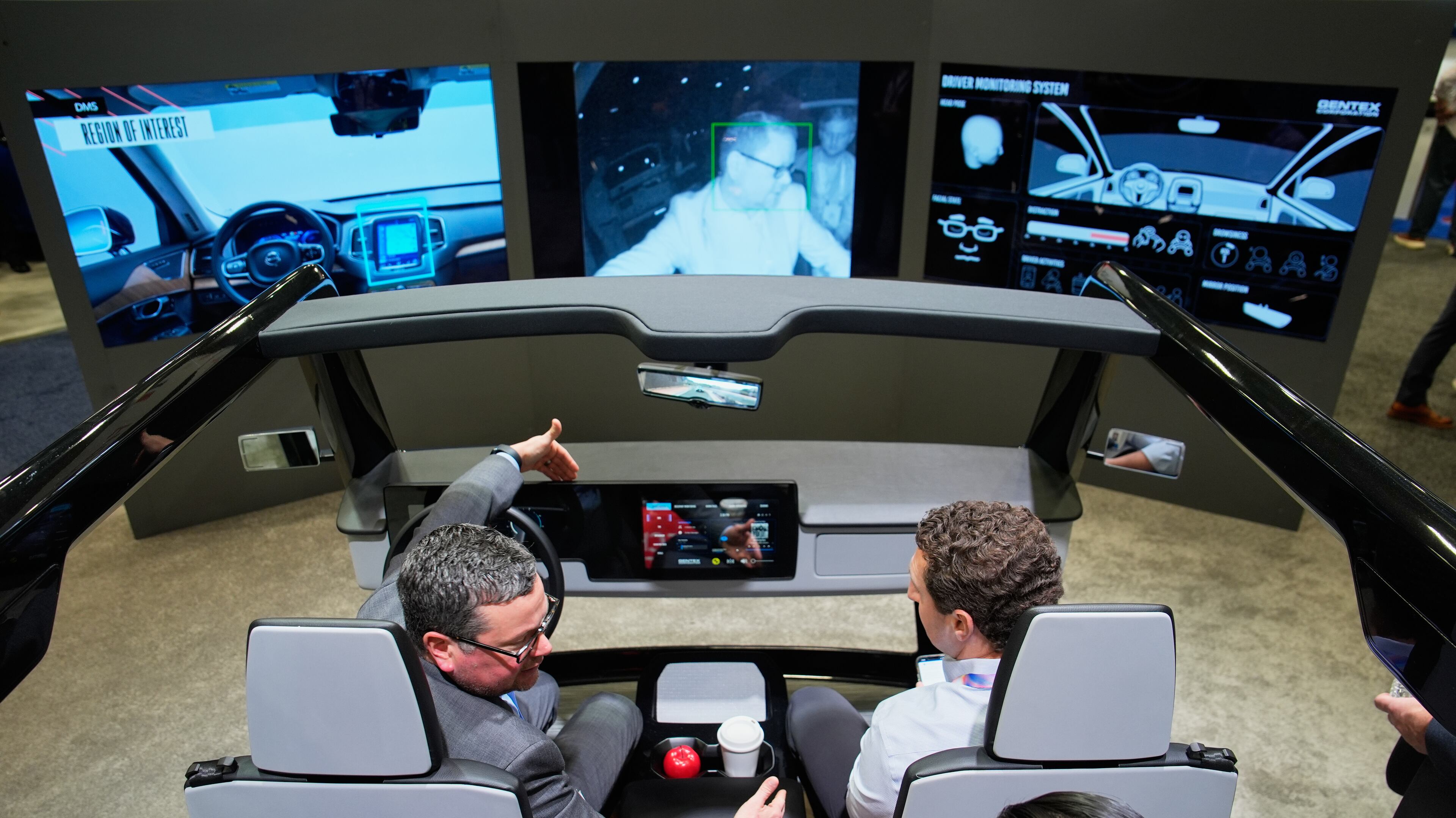 People experience a Gentex Corporation driver and in-camera monitoring system exhibit during the CES tech show Tuesday, Jan. 6, 2026, in Las Vegas. (AP Photo/John Locher)