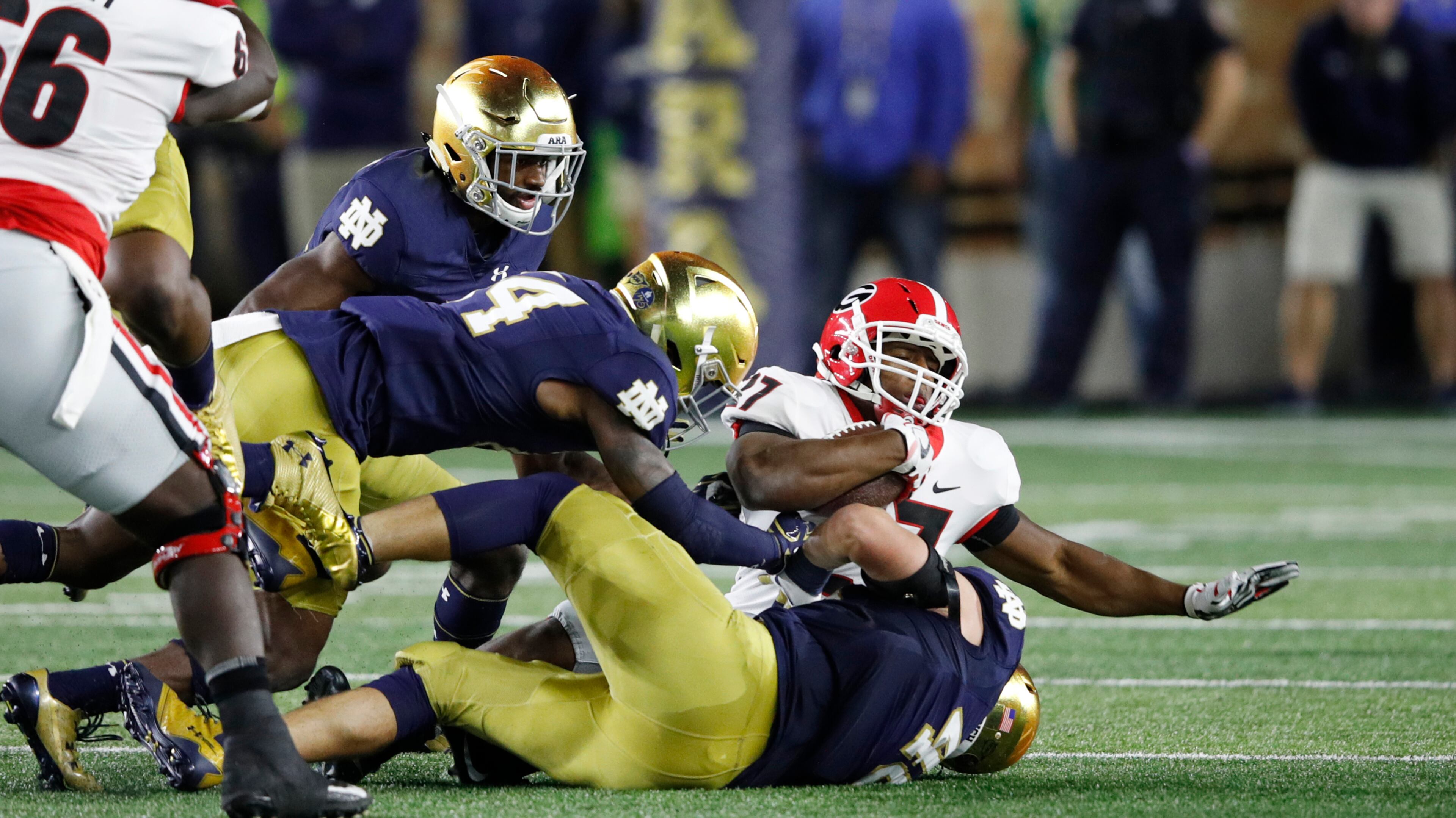 SOUTH BEND, IN - SEPTEMBER 09: Nick Chubb #27 of the Georgia Bulldogs gets tackled by a group of Notre Dame Fighting Irish defenders in the second quarter of a game at Notre Dame Stadium on September 9, 2017 in South Bend, Indiana. (Photo by Joe Robbins/Getty Images)