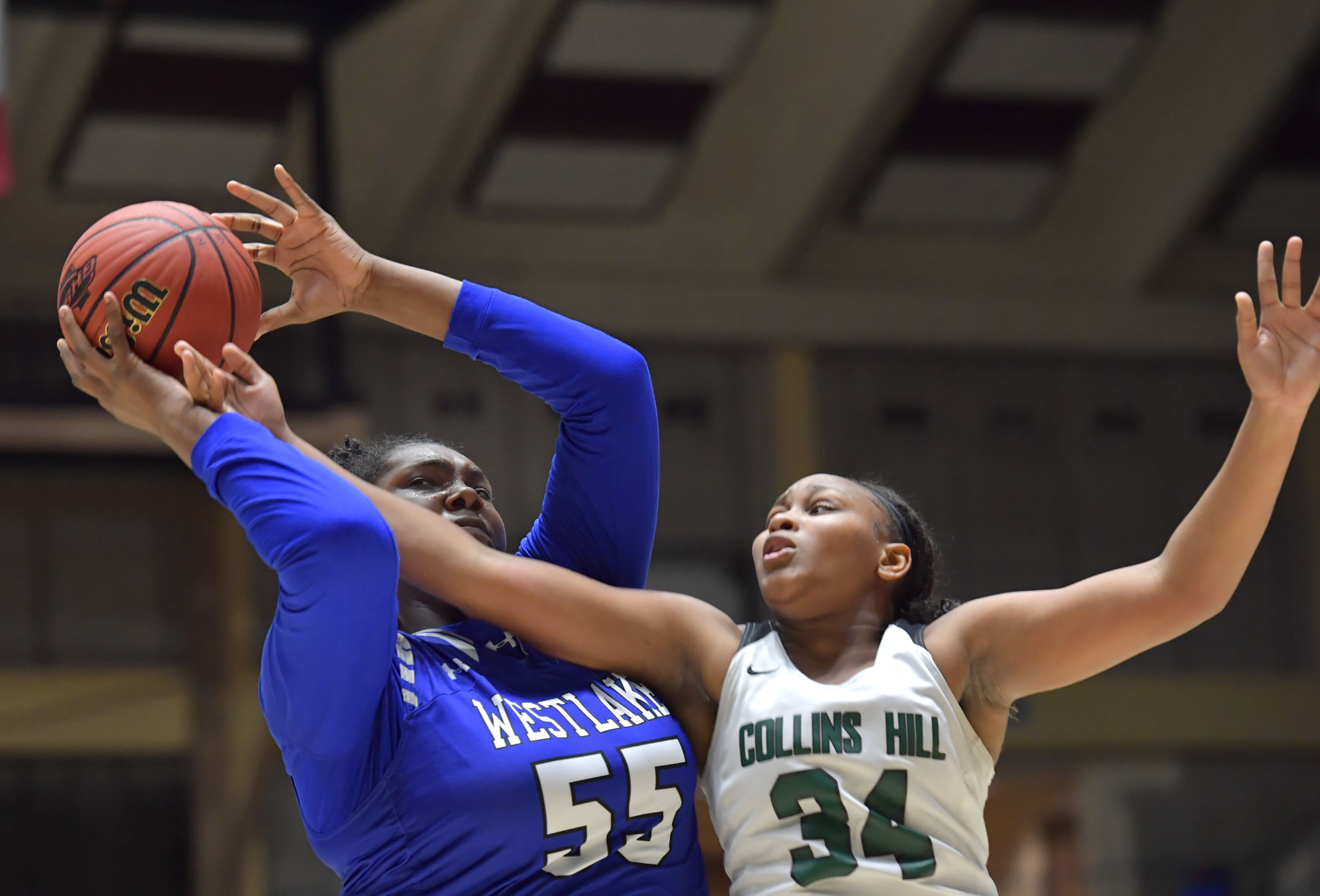 March 9, 2019 Macon - Westlake Lydia Freeman (55) and Collins Hill Yameah Elliott (34) fight for a rebound in GHSA State Basketball Championship game at the Macon Centreplex in Macon on Saturday, March 9, 2019. HYOSUB SHIN / HSHIN@AJC.COM