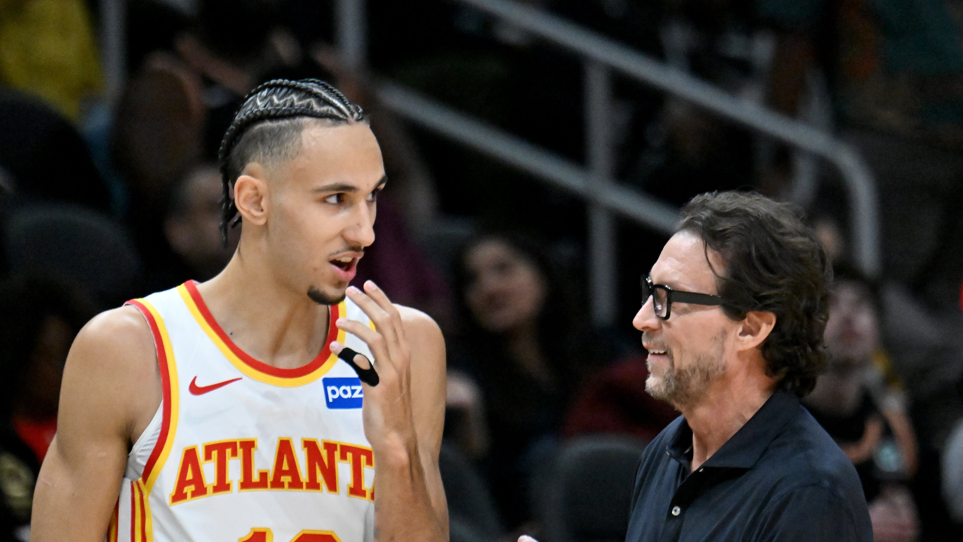 Hawks coach Quin Snyder (right) talks to forward Zaccharie Risacher during the first half Wednesday, Jan. 7, 2026, against the Pelicans at State Farm Arena in Atlanta. Risacher has missed the last eight games since scoring a game-high 25 points on 7-of-9 3-point shooting against New Orleans. (Hyosub Shin/AJC)