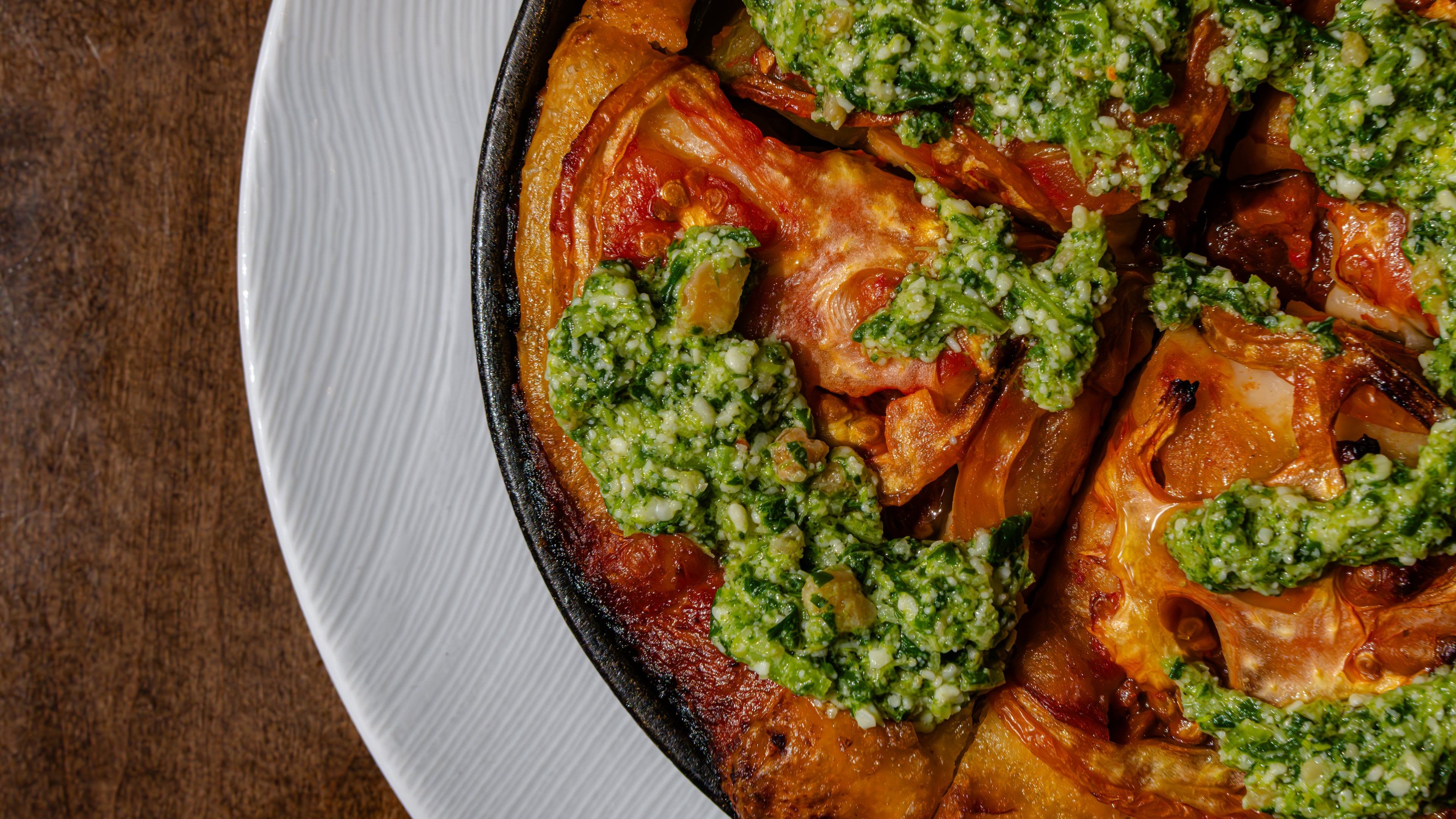 The focaccia barese is part of Scott Conant's latest Americano menu and includes Conant's pugliese focaccia topped with a broccoli rabe pesto and heirloom tomatoes. (Courtesy of Ken Goodman)