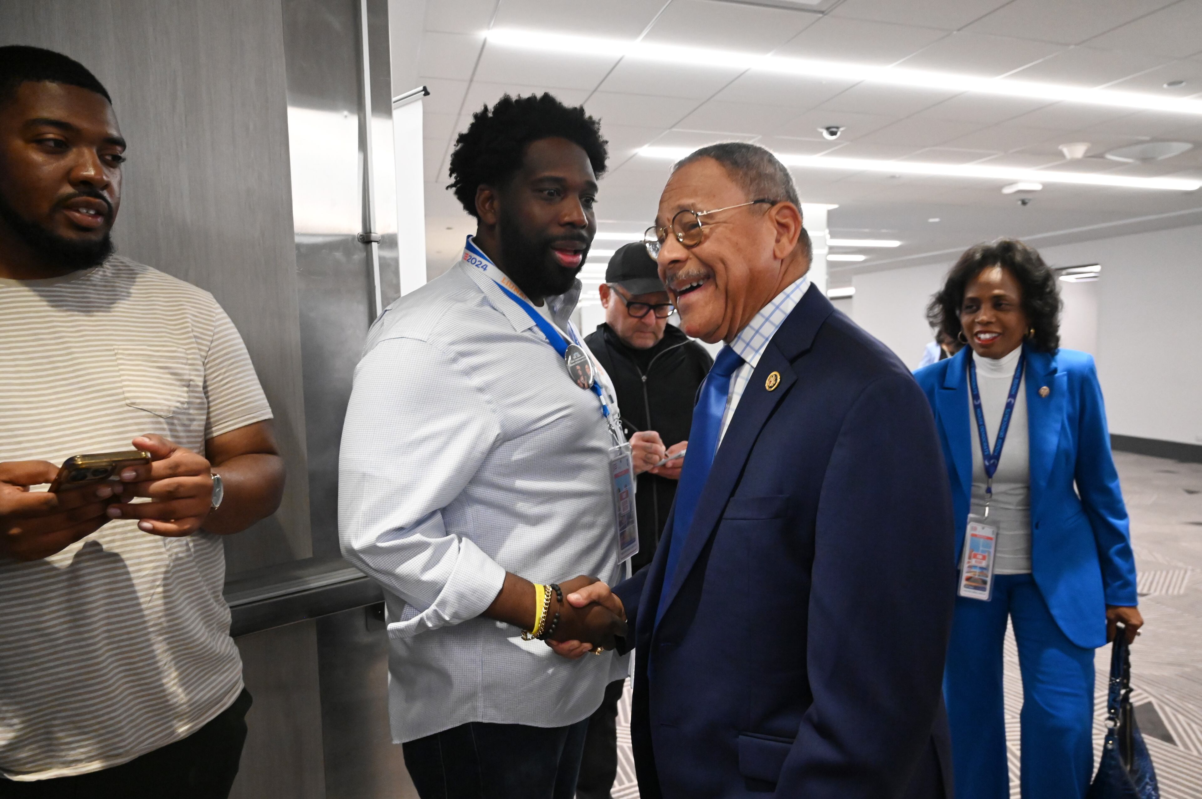U.S. Rep. Sanford Bishop (center right) smiles as he is greeted by Tolulope Kevin Olasanoye, executive director of Democratic Party of Georgia, at the Georgia delegation breakfast at the Hyatt Regency during the second day of the Democratic National Convention, Tuesday, August 20, 2024, in Chicago, Illinois. (Hyosub Shin / AJC)