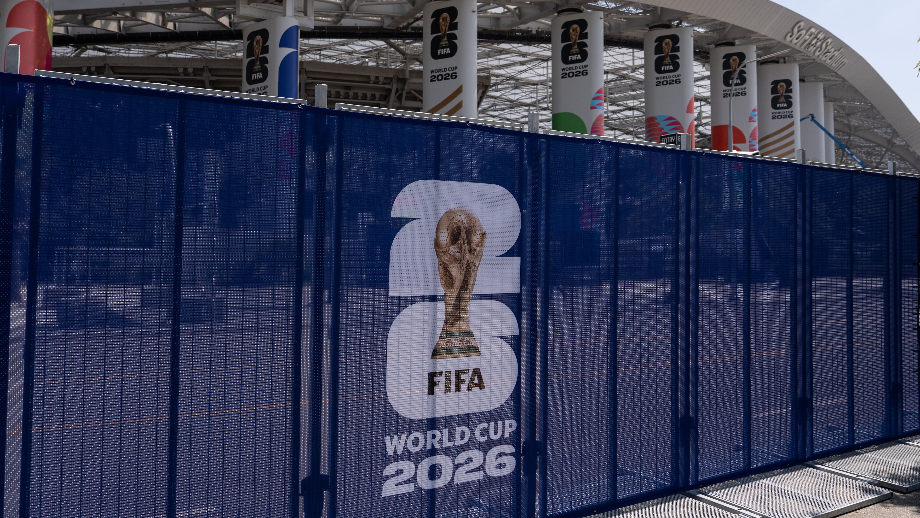 Temporary fencing with FIFA World Cup 2026 signage is set up outside SoFi Stadium, Friday, June 5, 2026, in Inglewood, Calif. (AP Photo/Jae C. Hong)