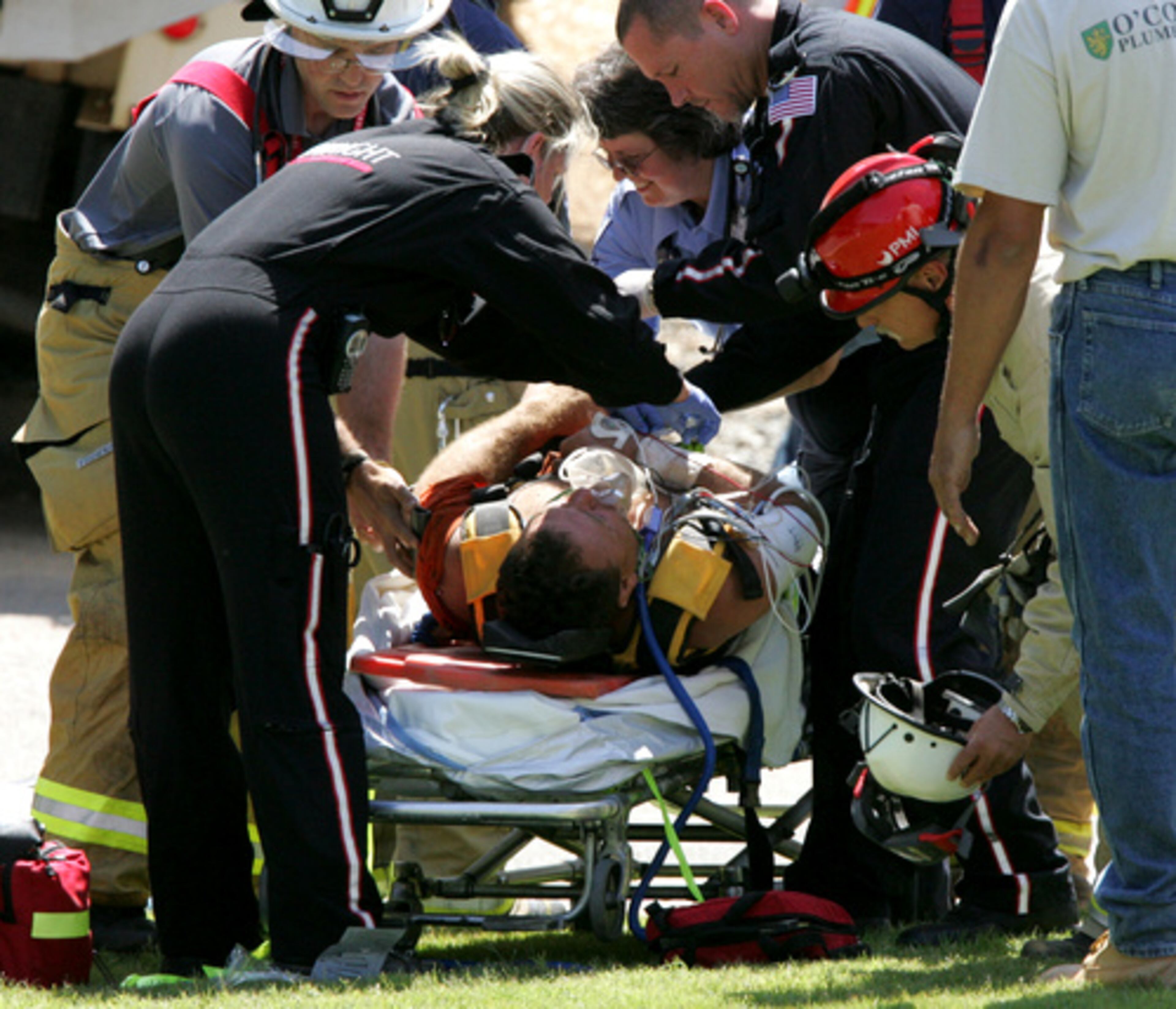 The construction worker is freed and about to be taken to the hospital.