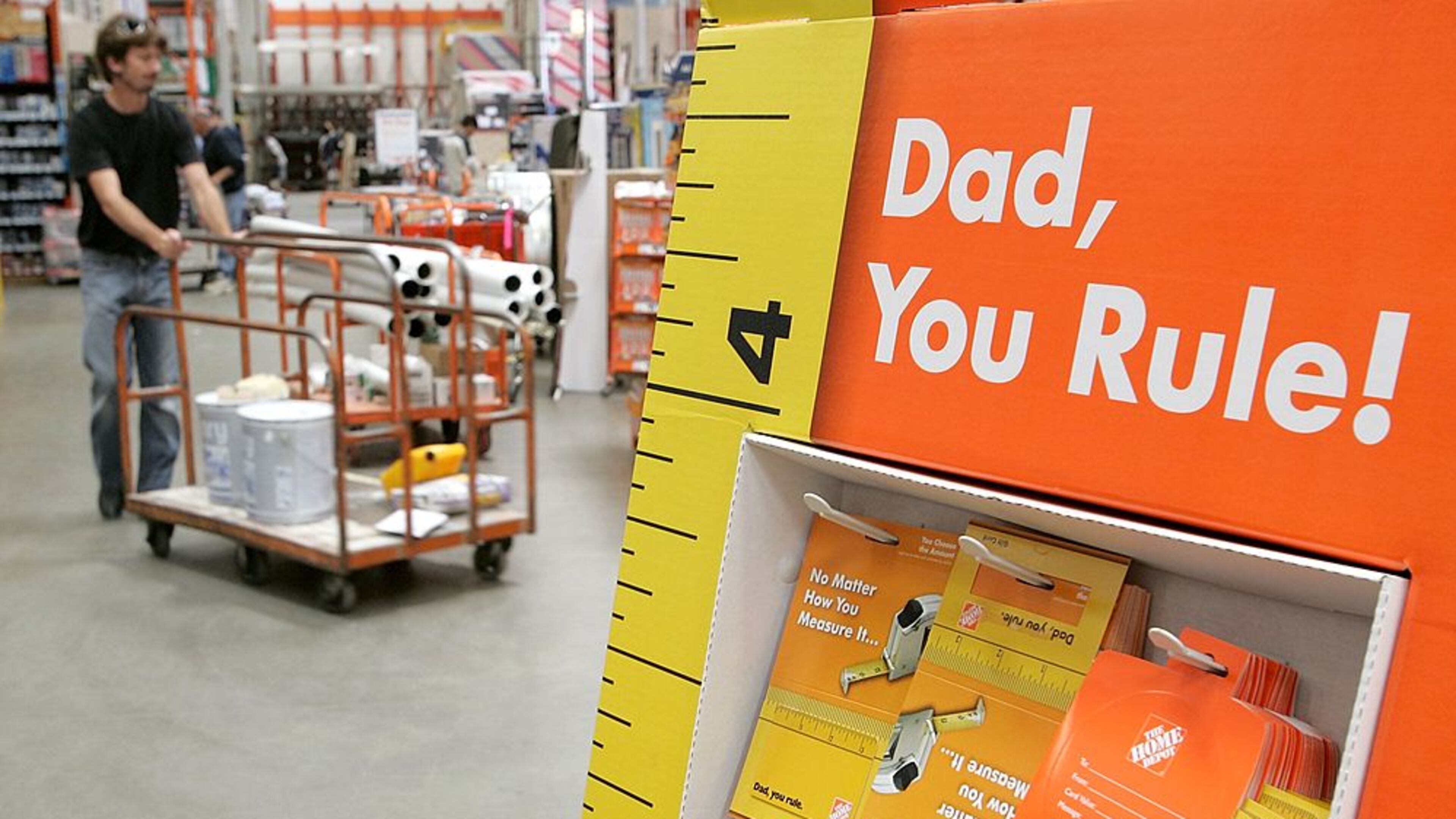 SAN RAFAEL, CA - JUNE 15: A Home Depot customer walks by a display of Father's Day gift cards at a Home Depot store on June 15, 2006 in San Rafael, California. Retail outlets are promoting Father's day gift buying in hopes that the holiday will become more profitable for businesses. (Photo by Justin Sullivan/Getty Images)