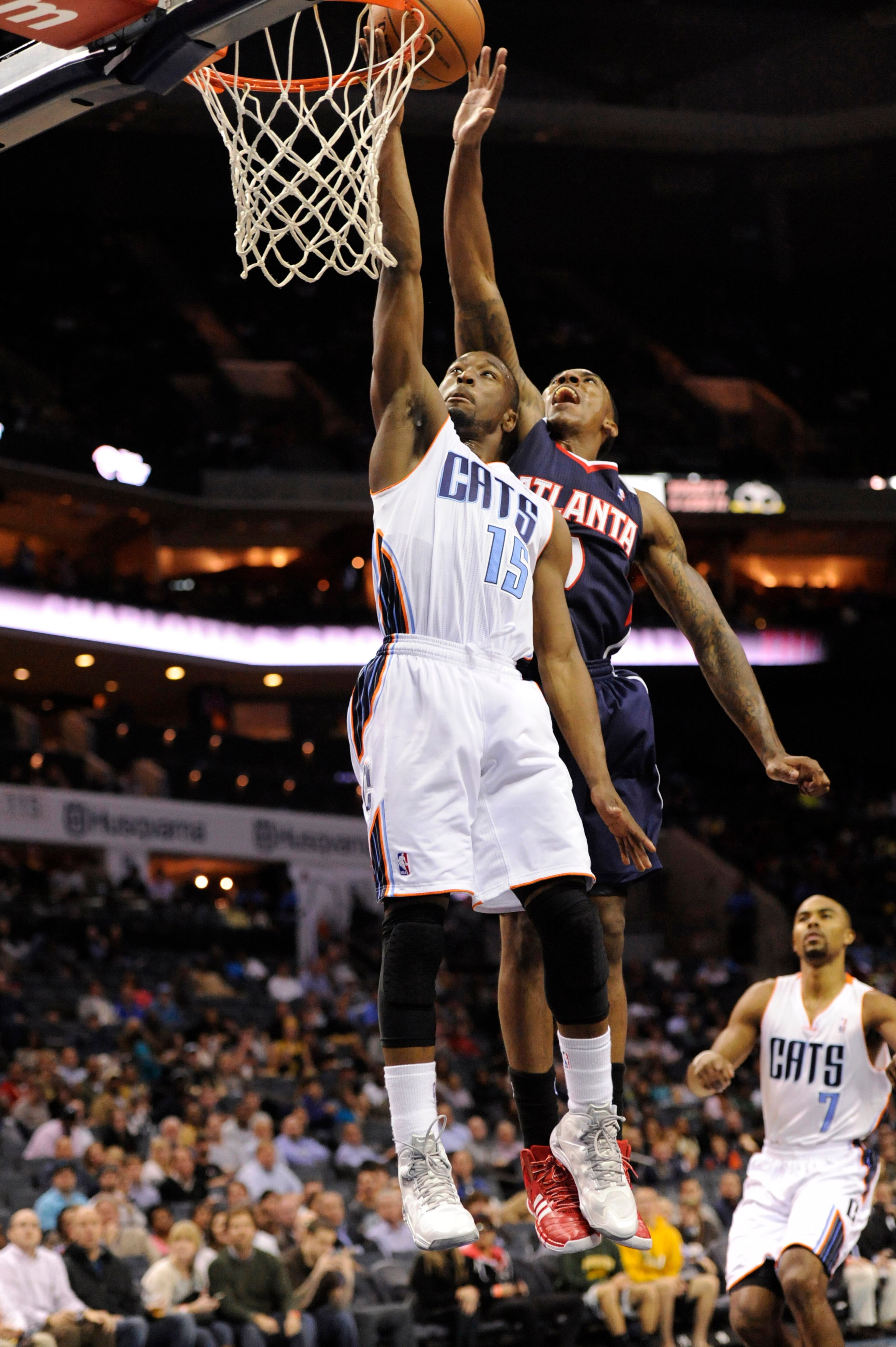 Charlotte Bobcats guard Kemba Walker (15) shoots the ball as Atlanta Hawks guard Jeff Teague (0) defends during the third quarter at Time Warner Cable Arena. The Hawks won 103-94. Mandatory Credit: Sam Sharpe-USA TODAY Sports