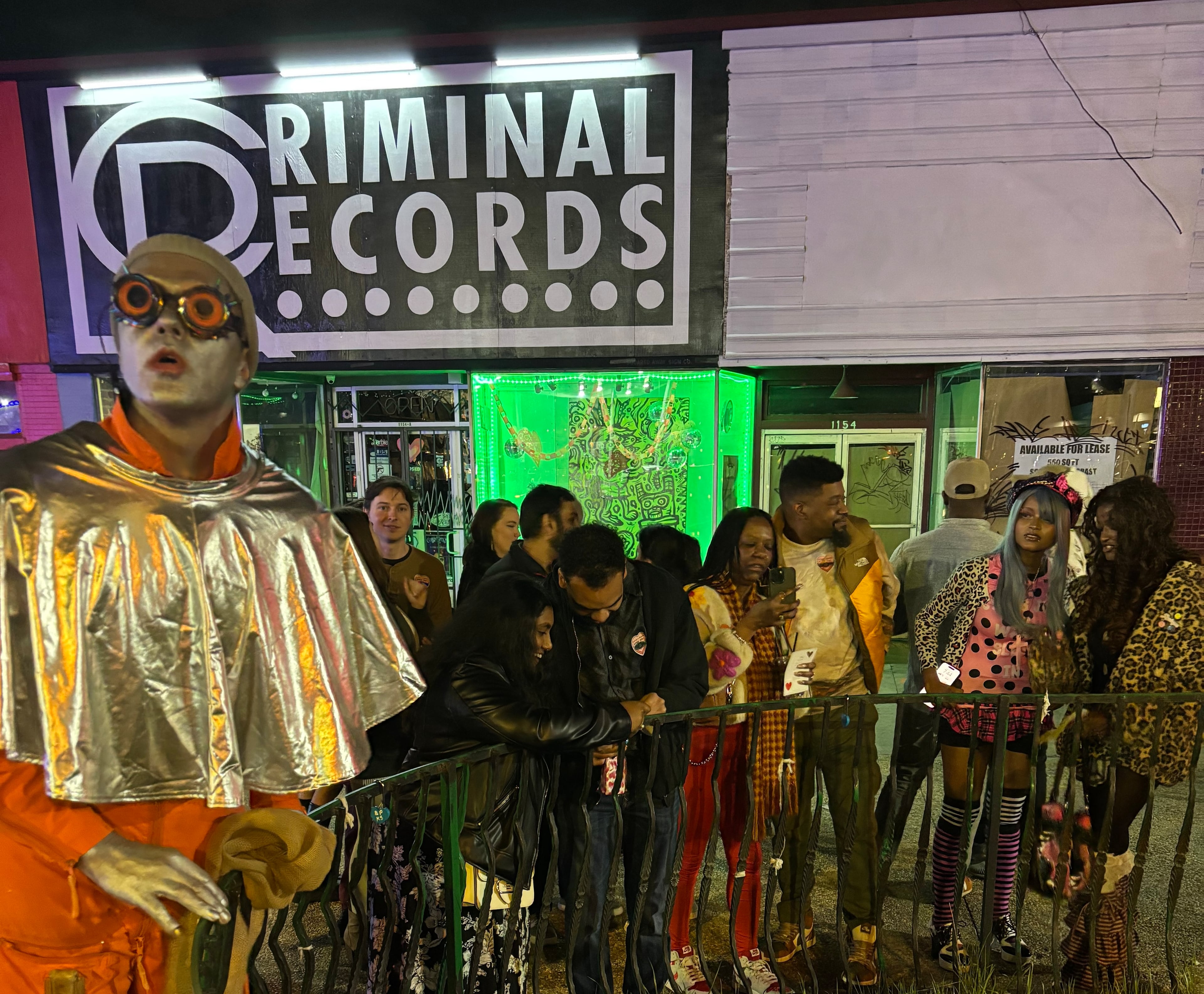 "Looking for Love in L5P" is a Valentine's Day roving theatrical experience produced by Media Res Immersive Theatre Company about an alien looking for his lover. Attendees will roam to five locations across the neighborhood to follow the show. Here artistic director Louis Kyper, dressed as an alien, stands in front of Criminal Records during the inaugural 2024 show. (Courtesy of Louis Kyper)