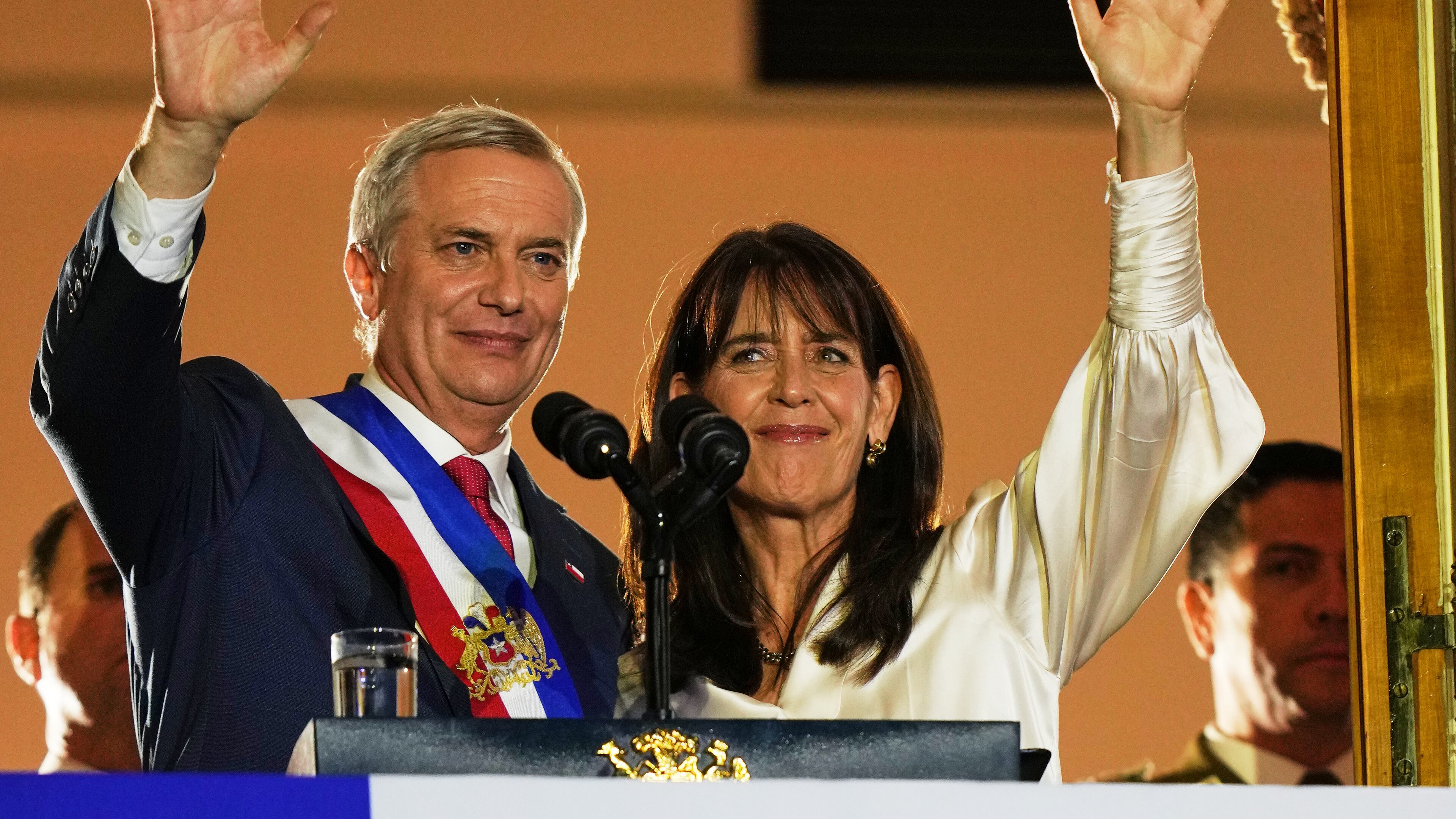 Chile's President Jose Antonio Kast and his wife Maria Pia Adriasola wave to supporters from the balcony of La Moneda presidential palace after his inauguration in Santiago, Chile, Wednesday, March 11, 2026. (AP Photo/Esteban Felix)