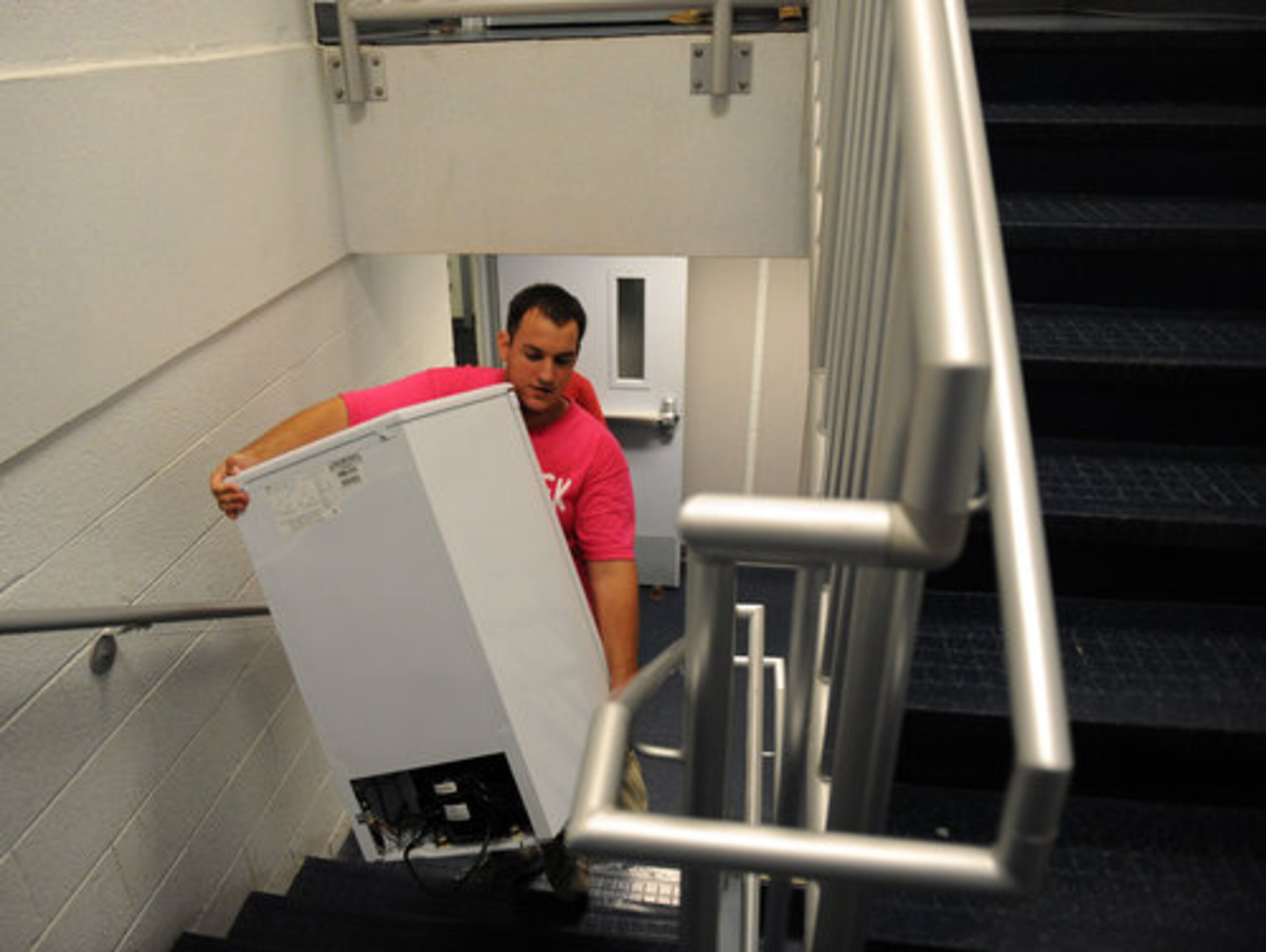 Moving a mini-refrigerator up four flights of stairs is no problem for sophomore Bryan Cantwell, a member of the Greek Club.
