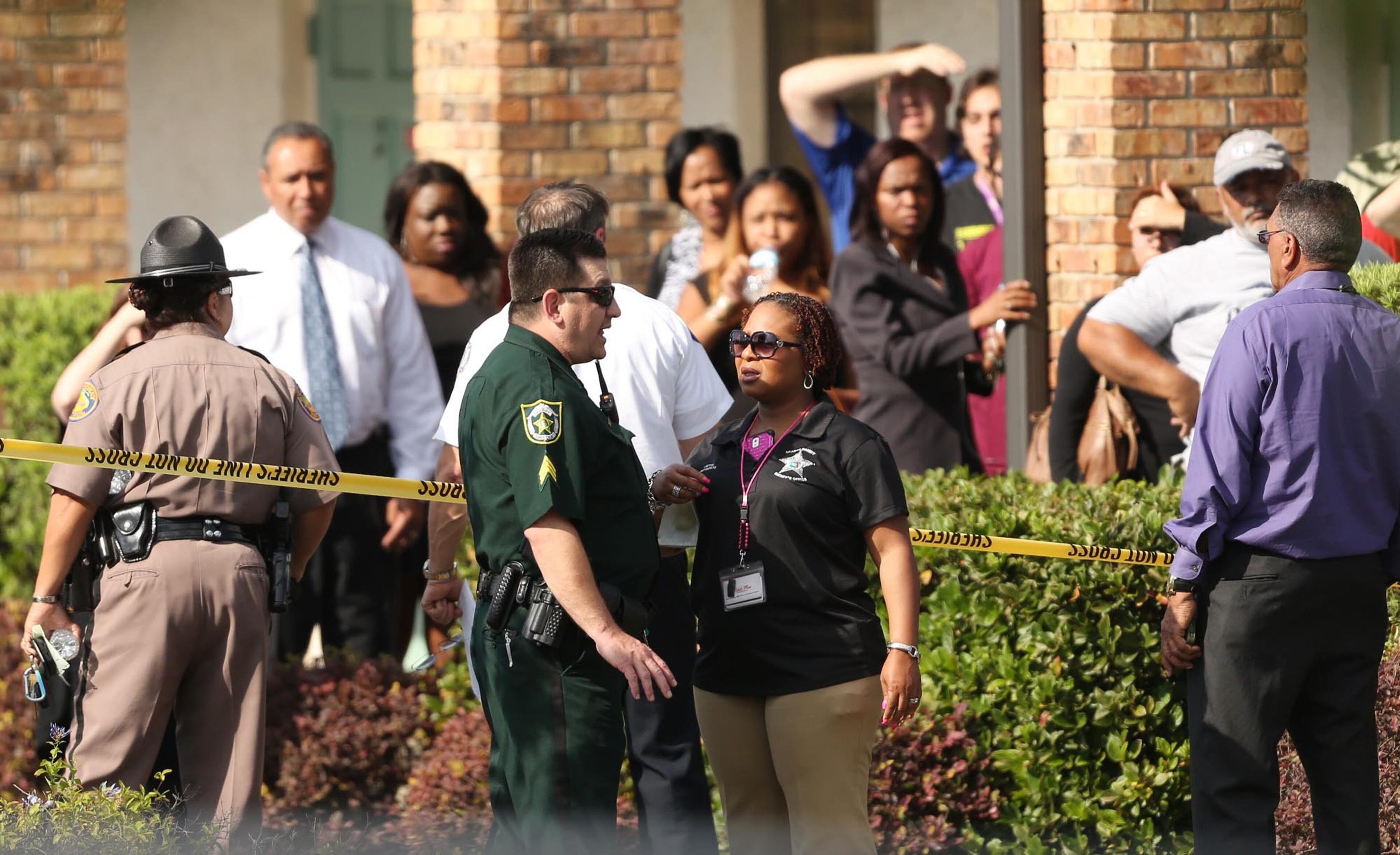 Parents wait outside the KinderCare Learning Center in Winter Park, Fla., a car crashed into the facility Wednesday, April 9, 2014. (Stephen M. Dowell, Orlando Sentinel/MCT)