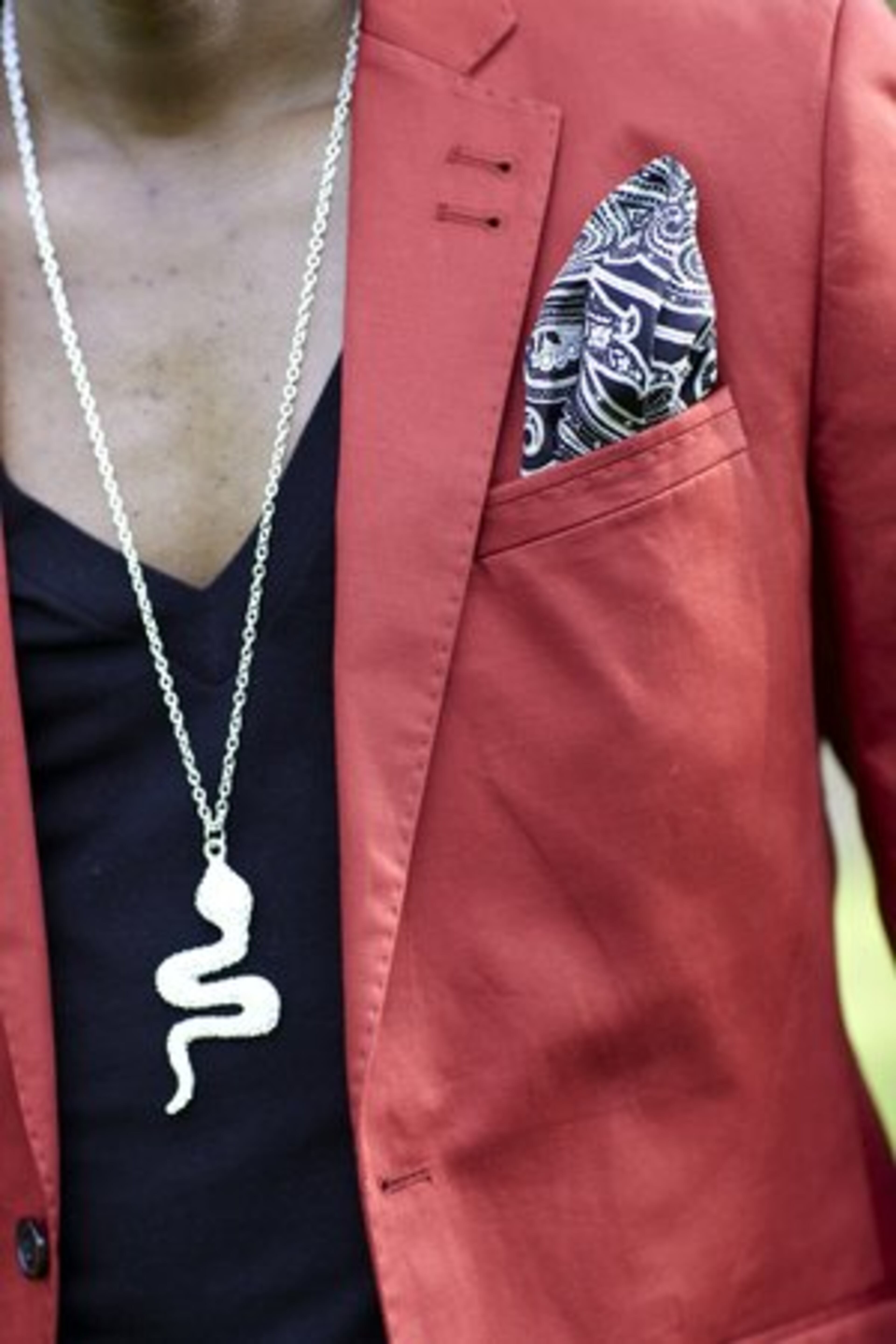 Taylor accessorizes his red sport jacket from Bloomingdale's with a silver chain and snake pendant necklace from a boutique in New York along with a pocket square from Daniel Cremieux.