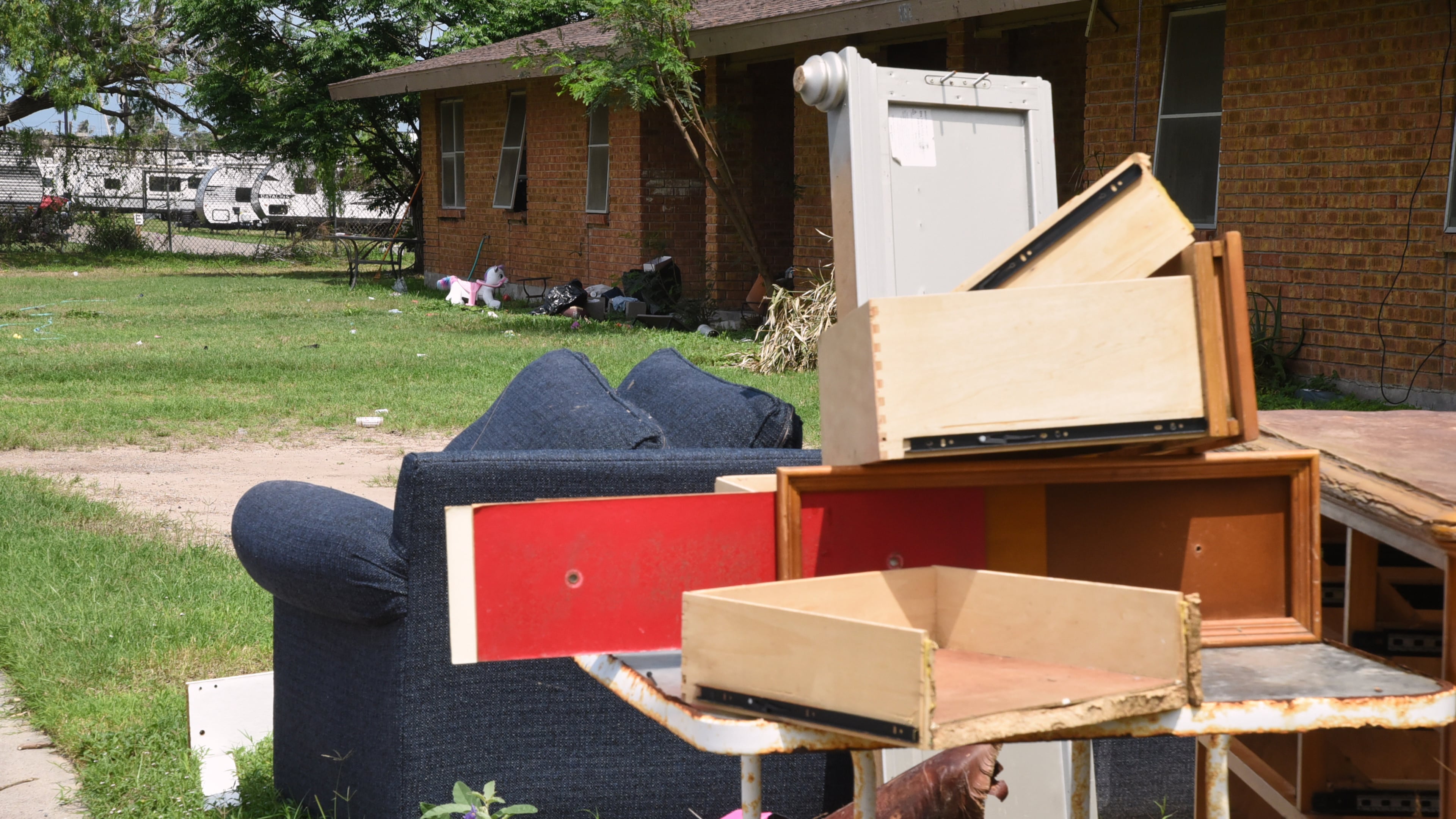 A pile of furniture is piled in a public housing subdivision in Port Isabel, Texas, on April 13, 2026. (AP Photo/Valerie Gonzalez)