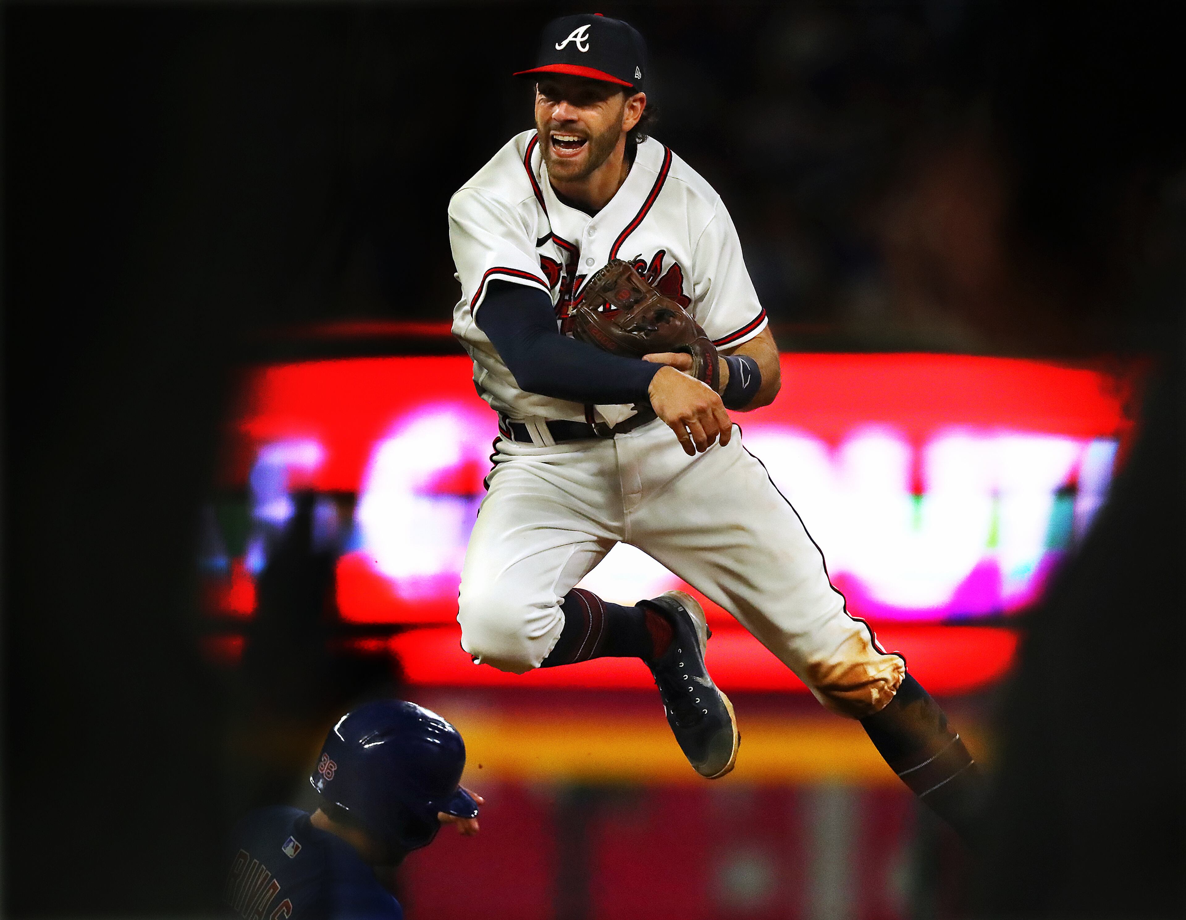 Atlanta Braves shortstop Dansby Swanson gets some air as he guns out Chicago Cubs Jayson Heyward during the 7th inning in a MLB baseball game on Thursday, April 28, 2022, in Atlanta. “Curtis Compton / Curtis.Compton@ajc.com”